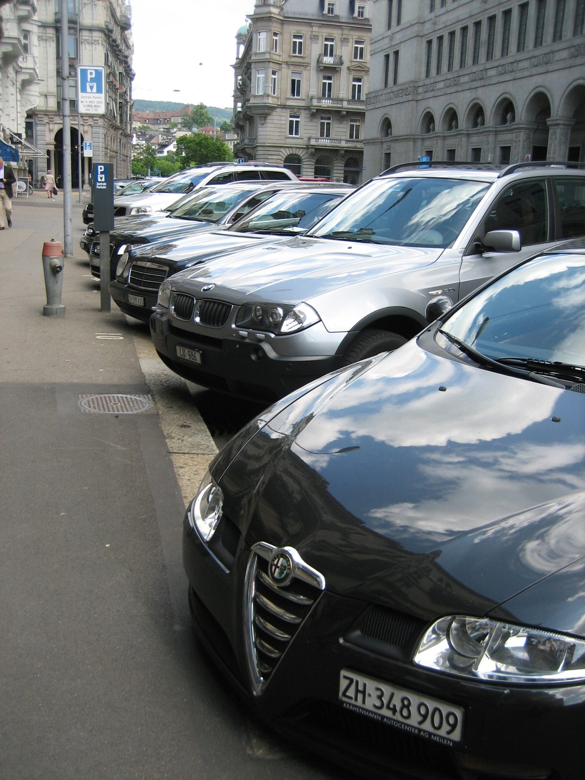 This was not an uncommon sight: a row of cars, starting with an Alfa Romeo and passing by some...