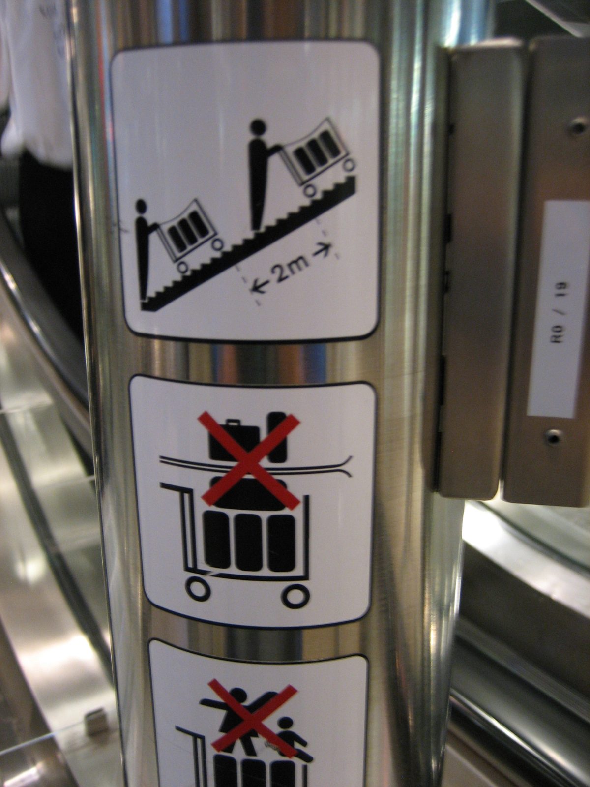 In the airport.  Luggage carts allowed on escalators!  Just no skis or children on the luggage...