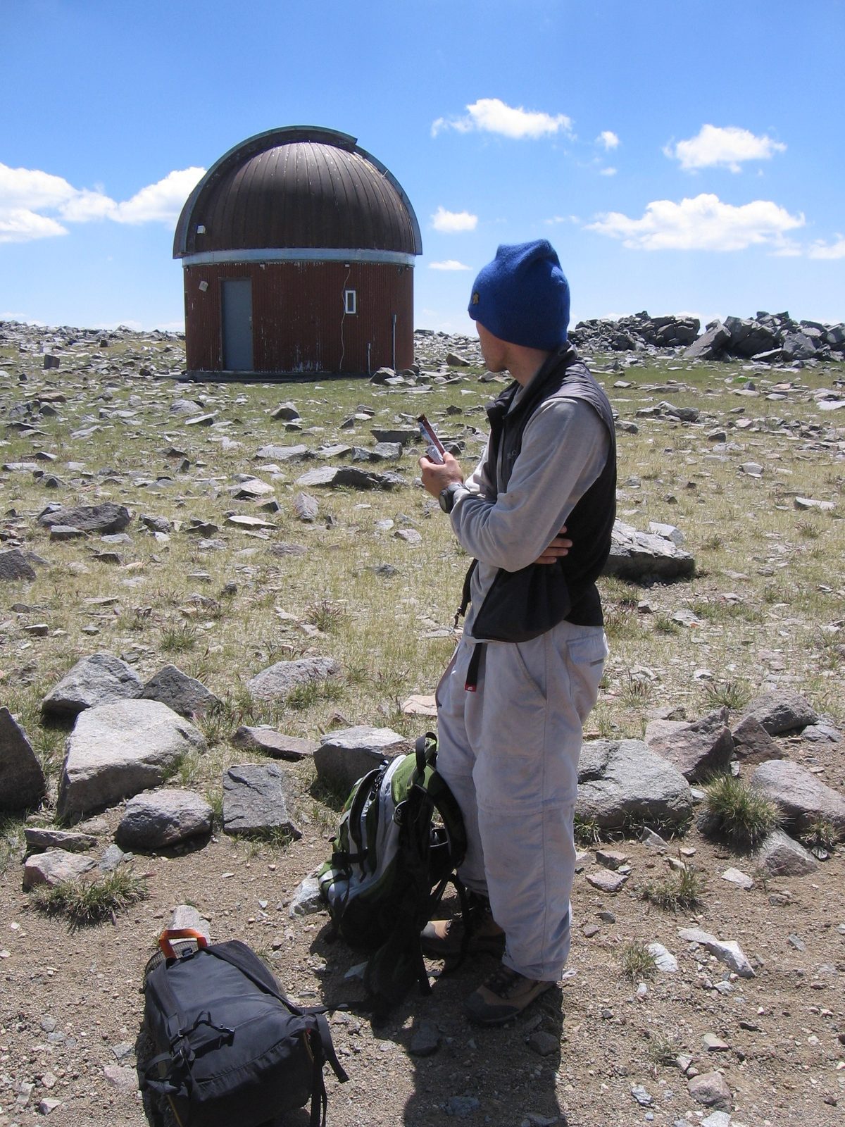 John snacking and looking at the observatory at 12,500 ft along the trail.