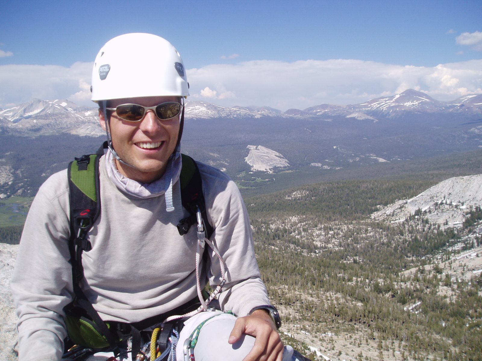 John sitting on the top of Cathedral Peak with Tuolumne Meadows and Lembert Dome in the background.