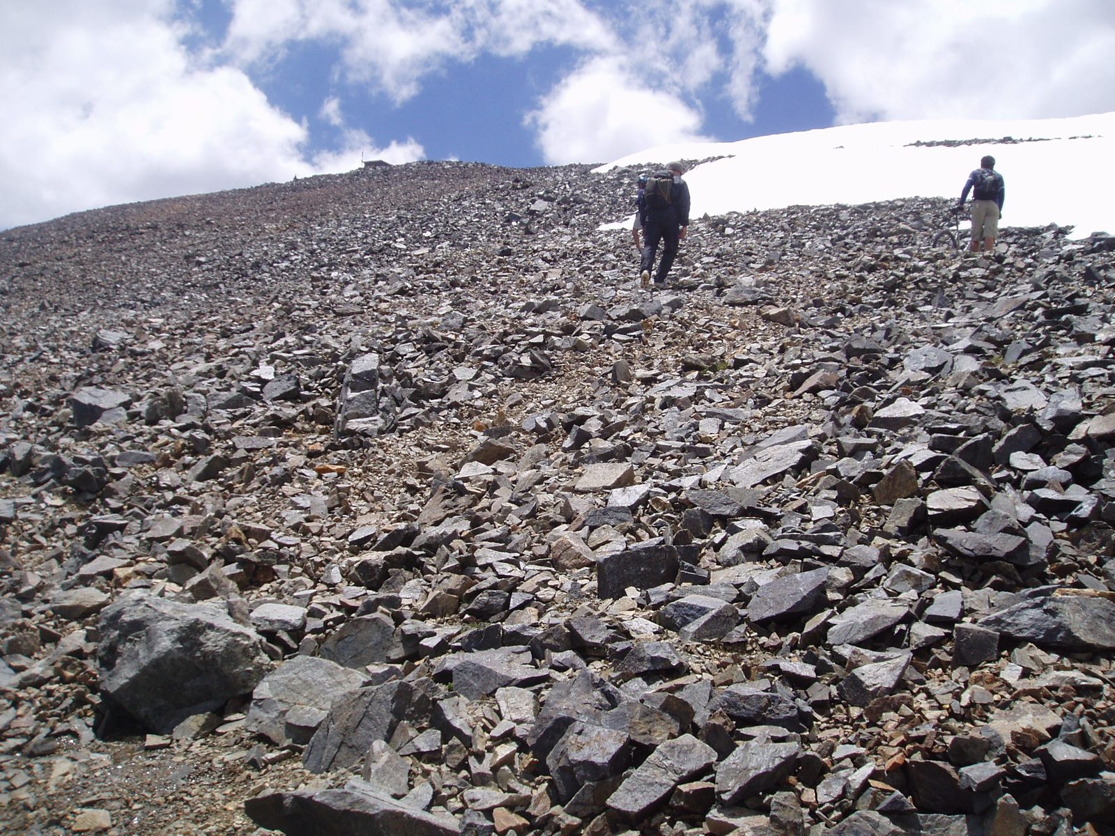 Srambling the scree field to avoid snow across the trail.  Not what you'd expect for July in the desert.