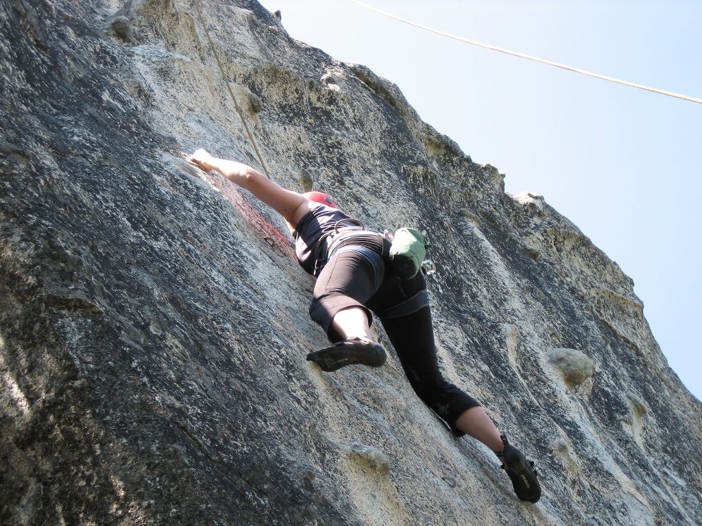 Sylvianne, reaching right for the next foot hold just past the crux on Blue Note.