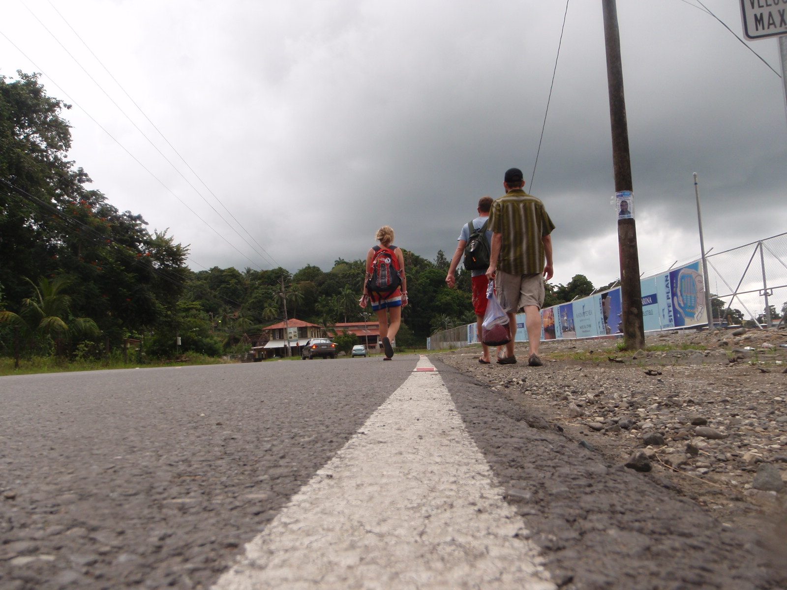 Morgan, Jasper and Joel walking down a road outside Quepos.