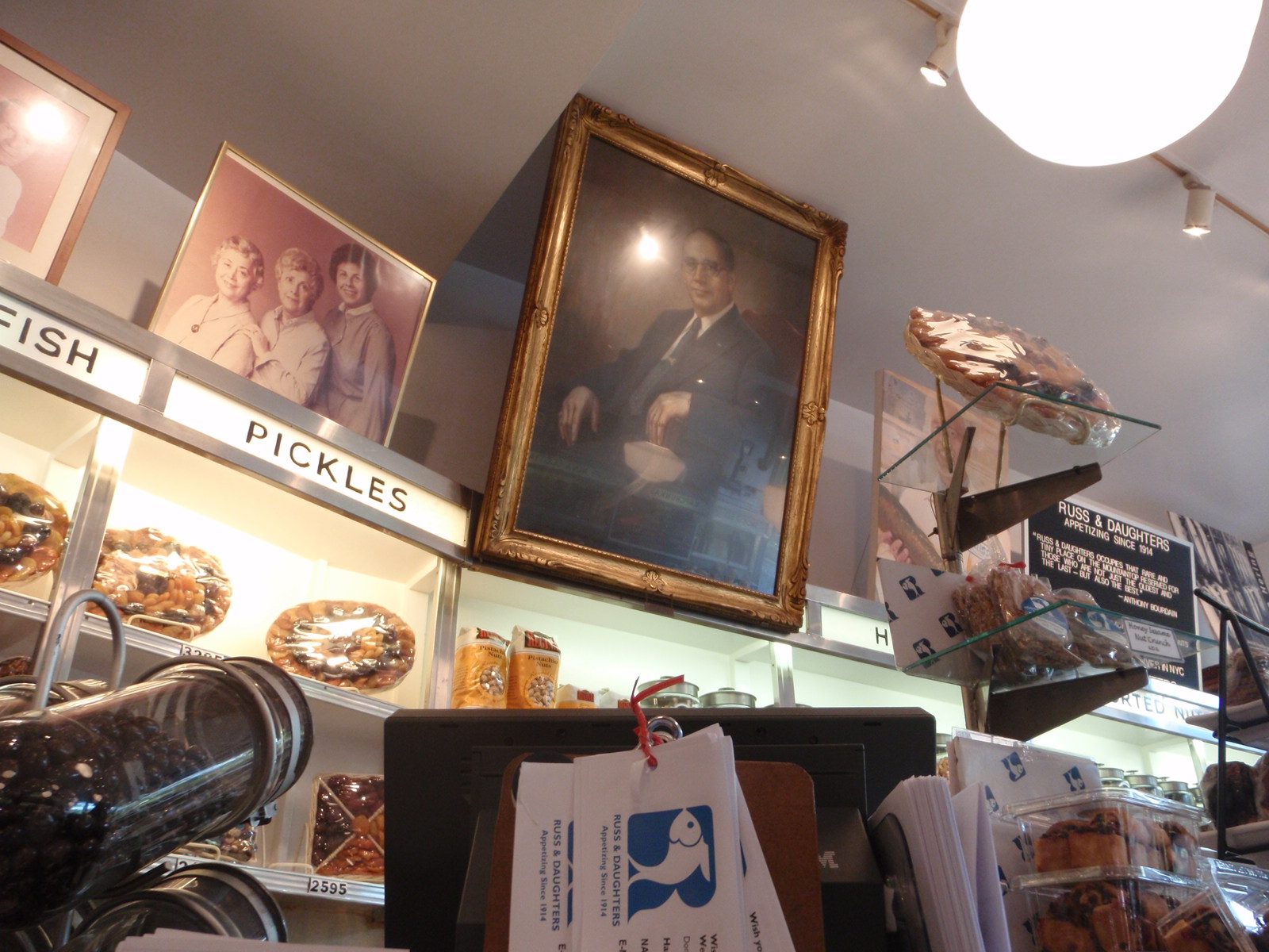 Portrait of Joel Russ, founder of the store hanging prominently over the sweet counter....