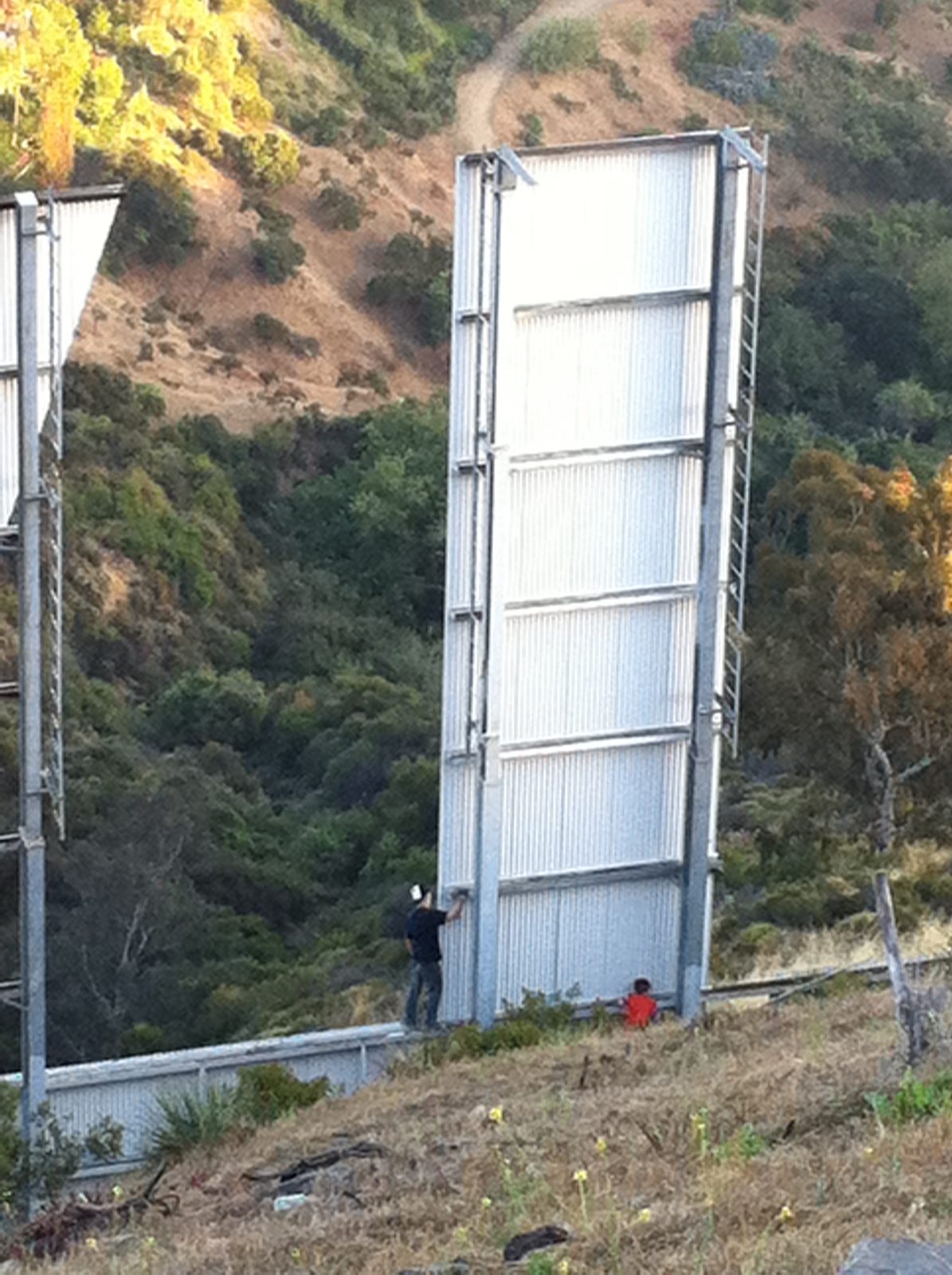 Some yokels were climbing on the sign, despite it being surrounded by chain link fence and...