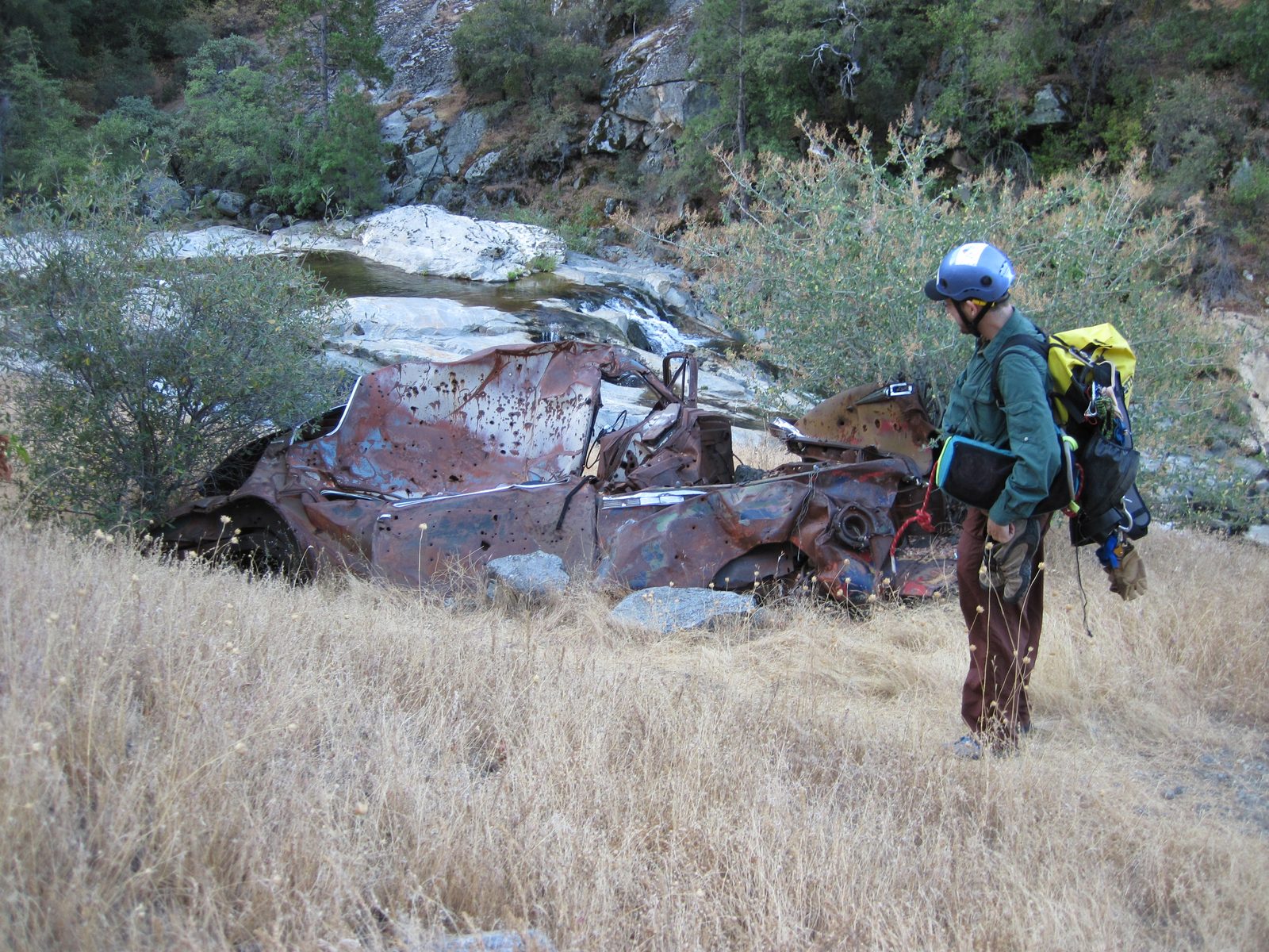 Joel inspects our favorite junked car at the river's edge, where Upper Jumps Trip finishes, and...