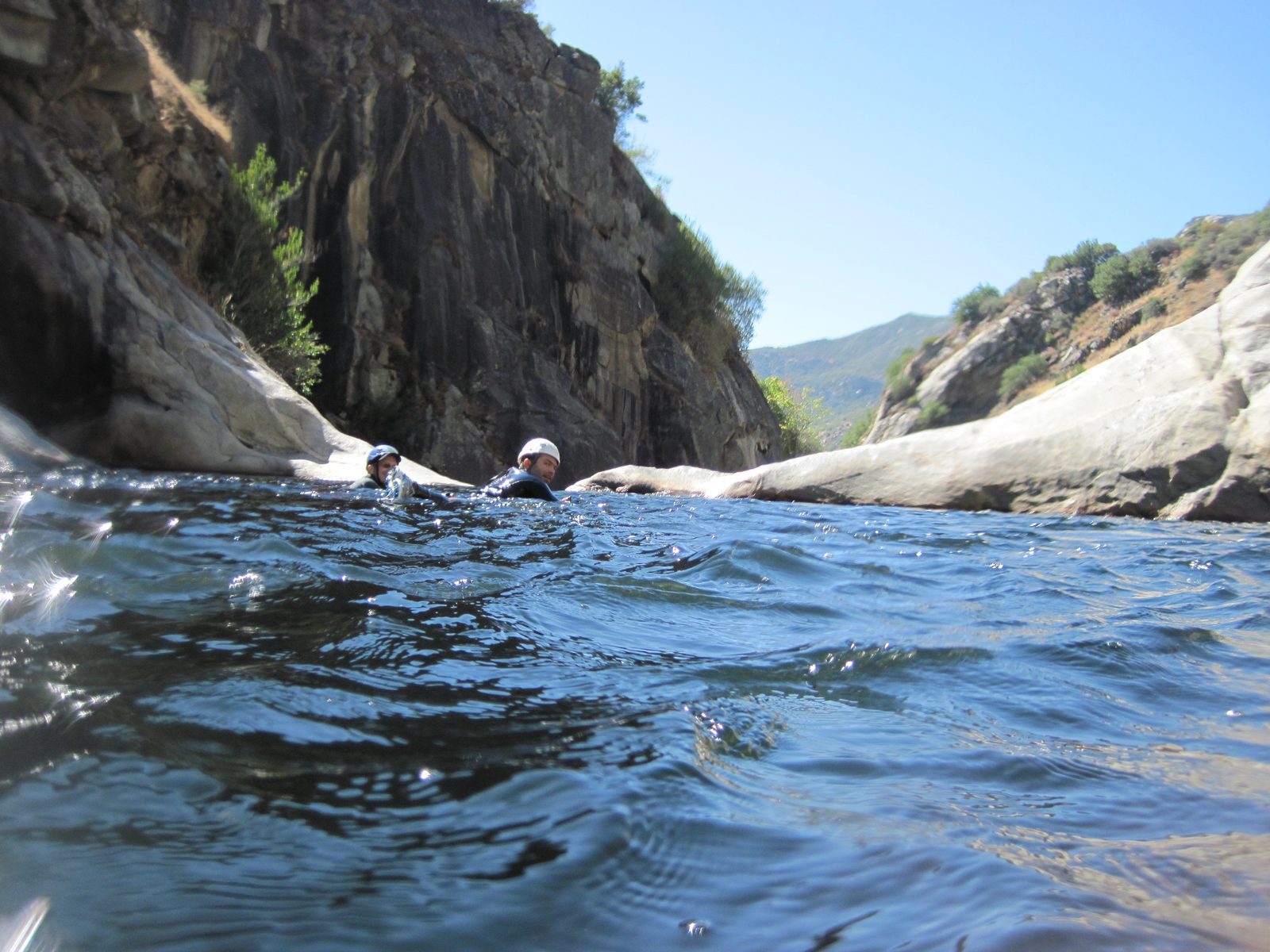 Swimming across a pothole to the next waterfall.