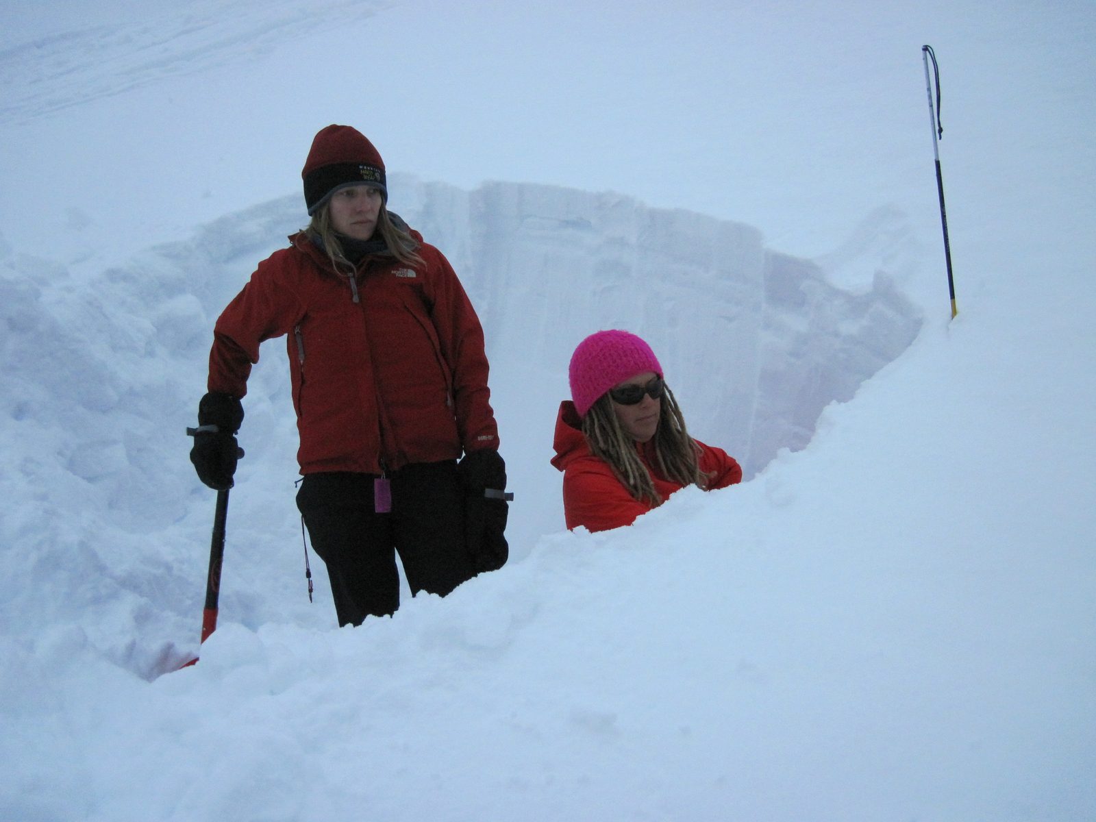Mara and Julie examine layers in our snow pit.