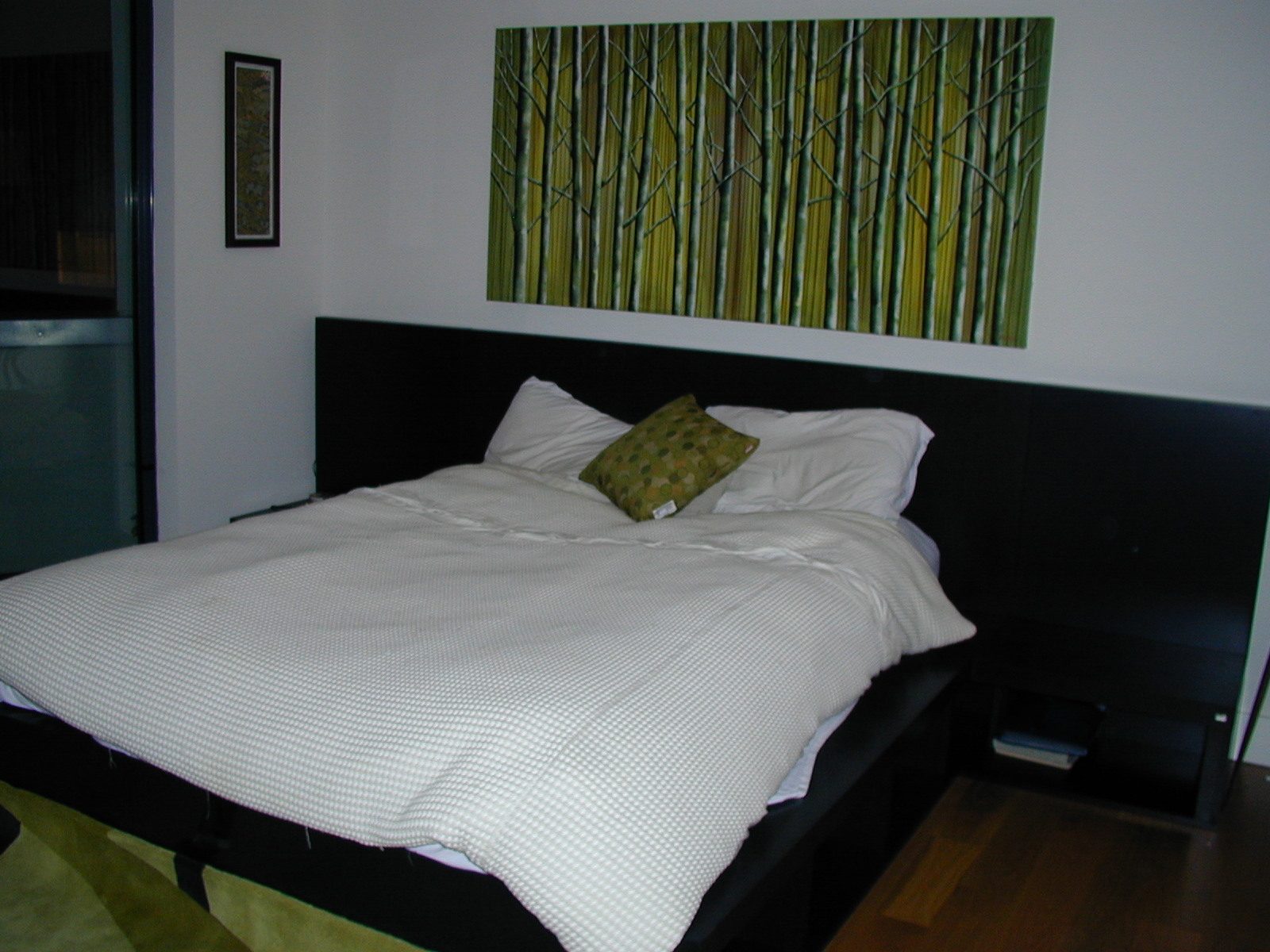 Standing at foot of bed.