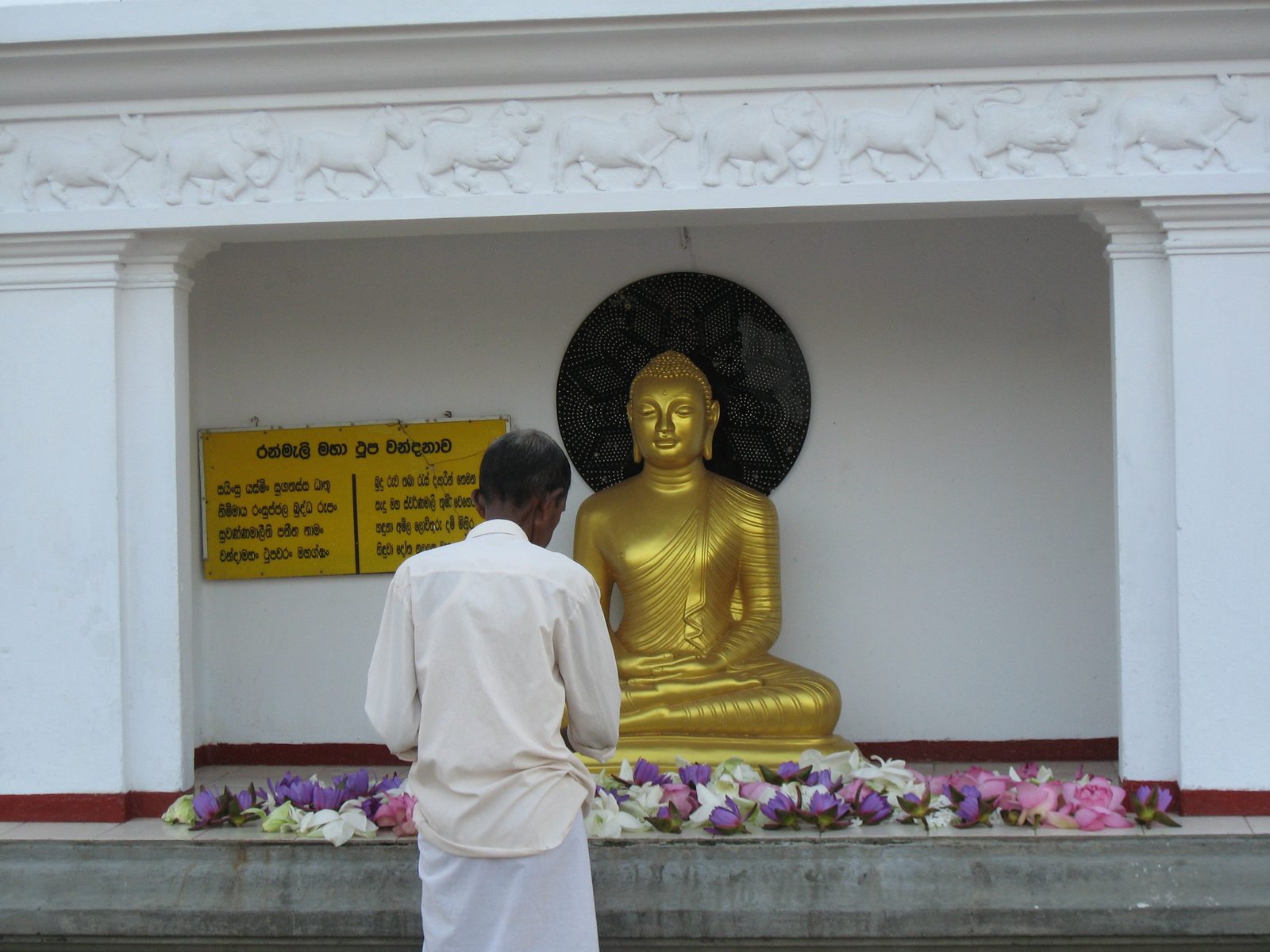 An older pious Buddhist Sri Lankan.
