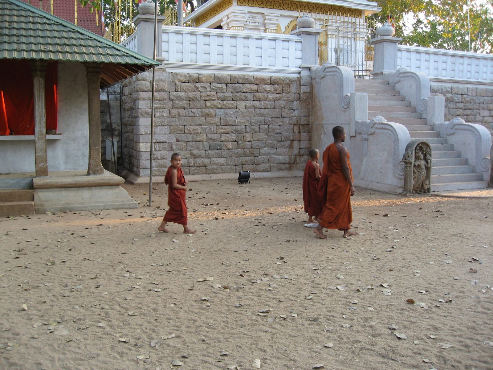 A monk leads two monks-in-training.