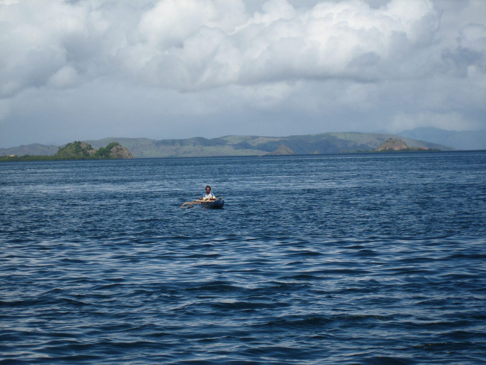 Kind of amazing some guy would be out here in a tiny outrigger canoe fishing with just a line...