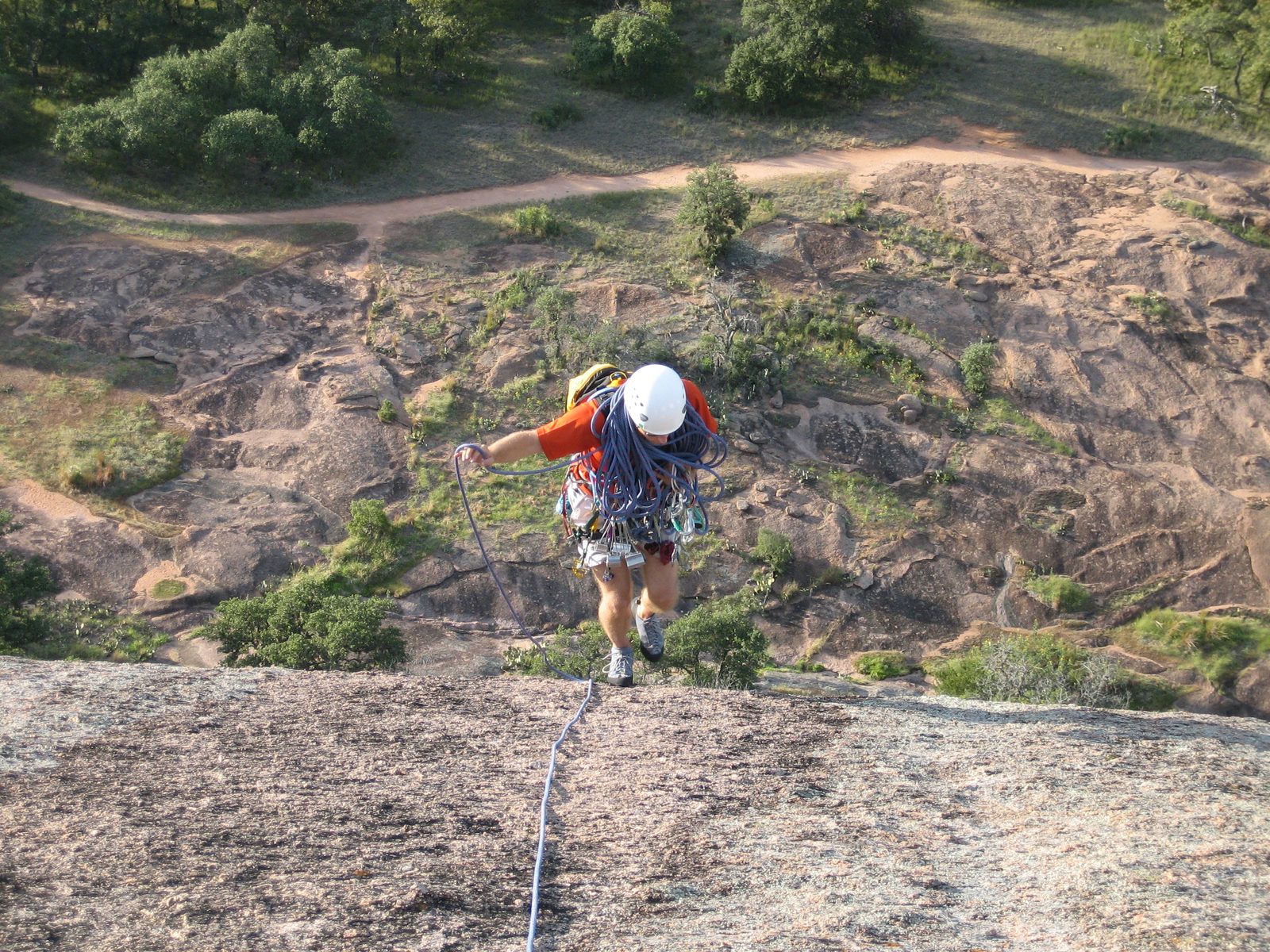 Walking off the low-angle slab at the top of Boston.  Ground with footpath in background. ...