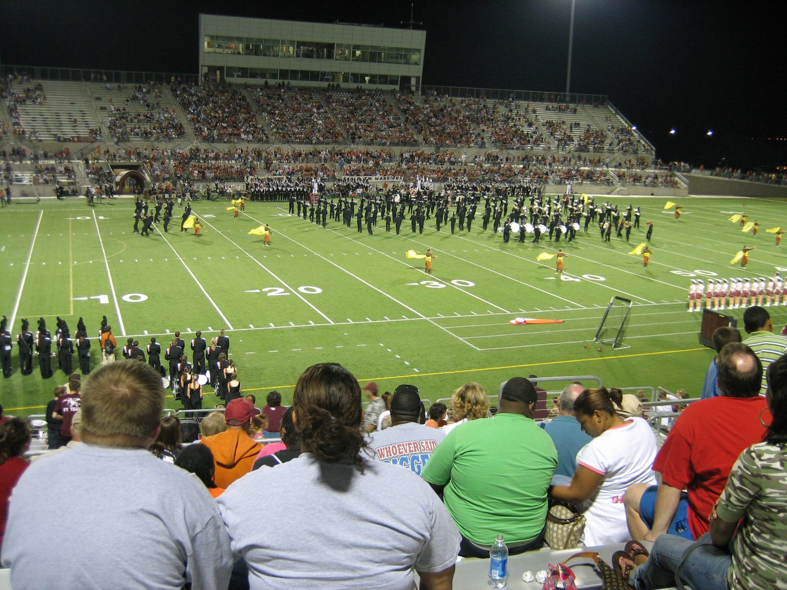 Some fine Round Rock citizens, out to cheer their team, with the band and the flag guard on the field.