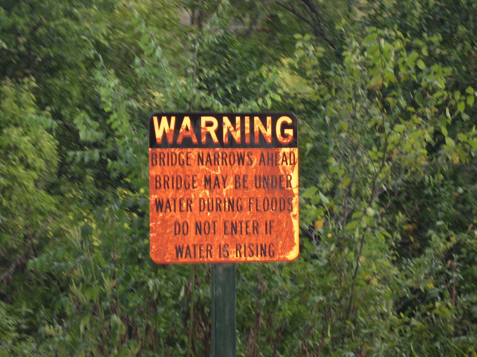"Warning: Bridge narrows ahead.  Bridge may be under water during floods.  Do not enter if water...