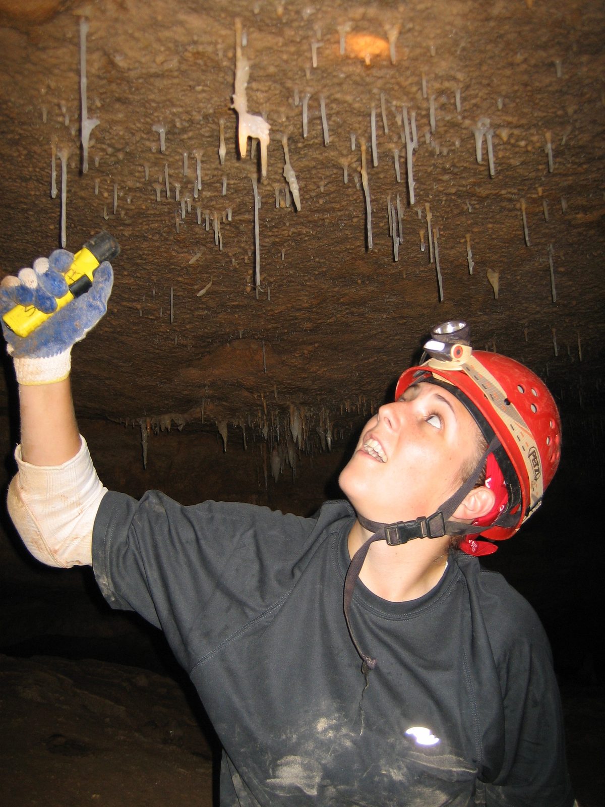 Catherine inspecting a helictite, a stalagtite that grows sideways.