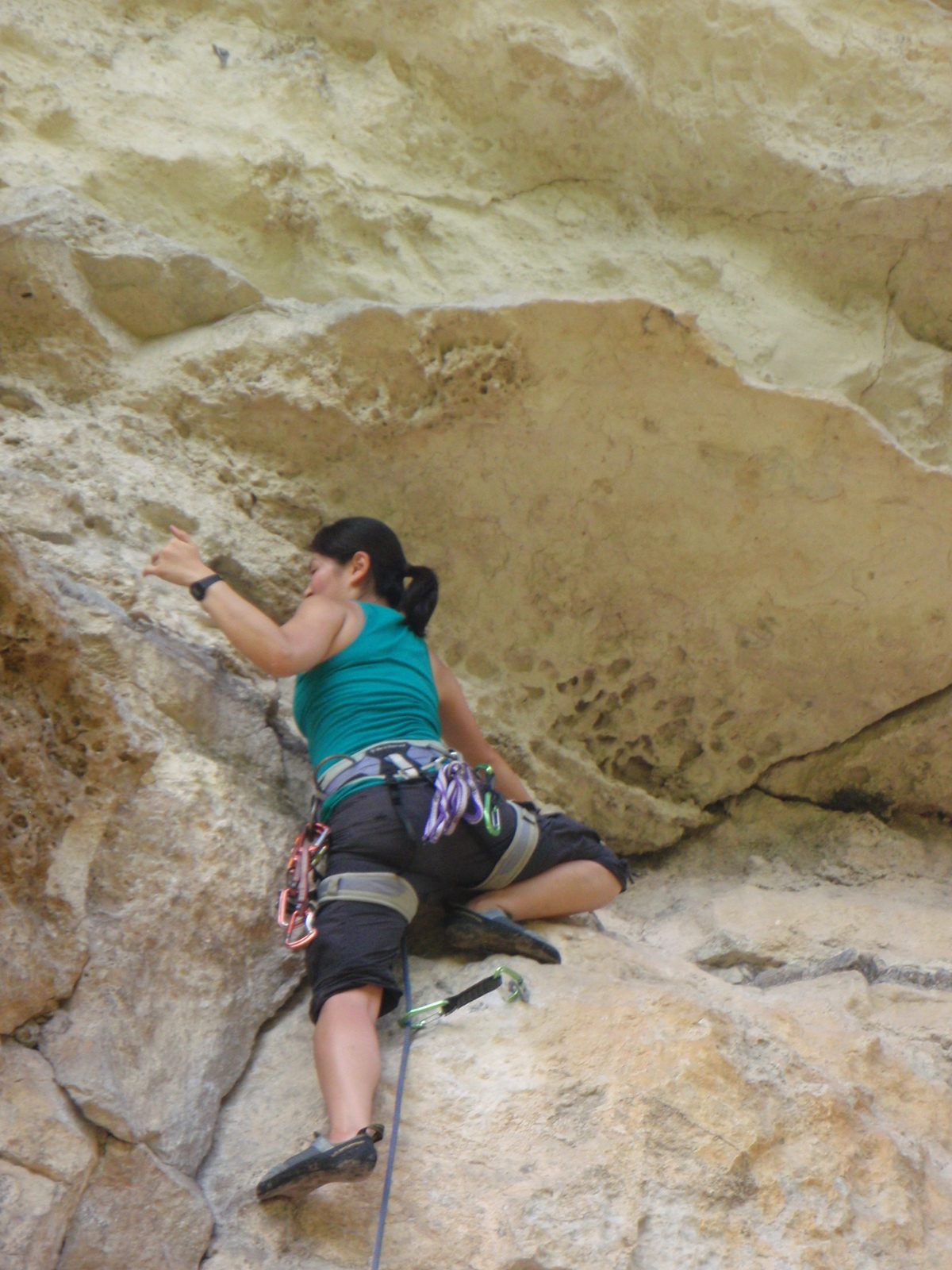 Monica on lead, about to pull the roof below the anchor.