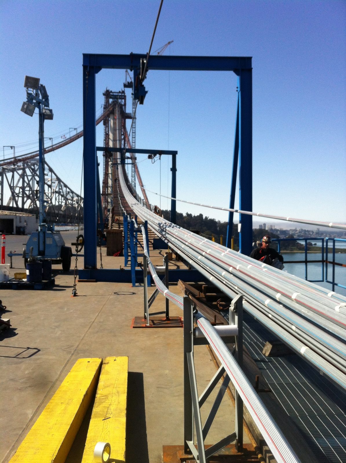Each of the cable bundles that are already strung are tensioned and packed more densely at the right.