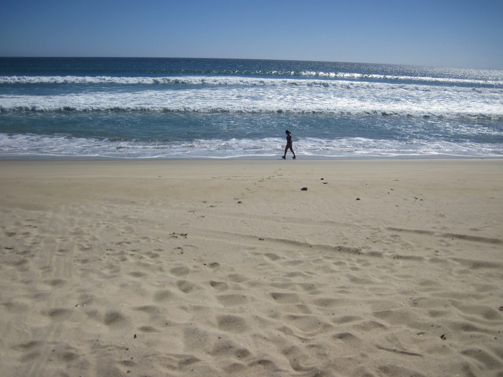 Monica walking on the beach.