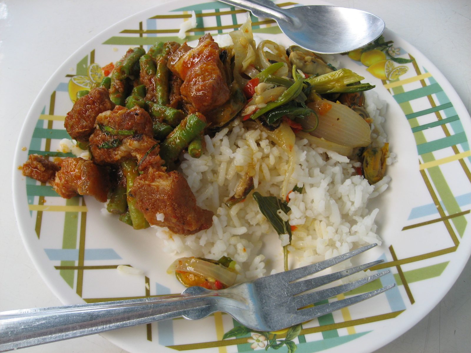 25 Thai Baht meal in Bangkok (about 75 cents).  Mussels and pork with long beans and rice.