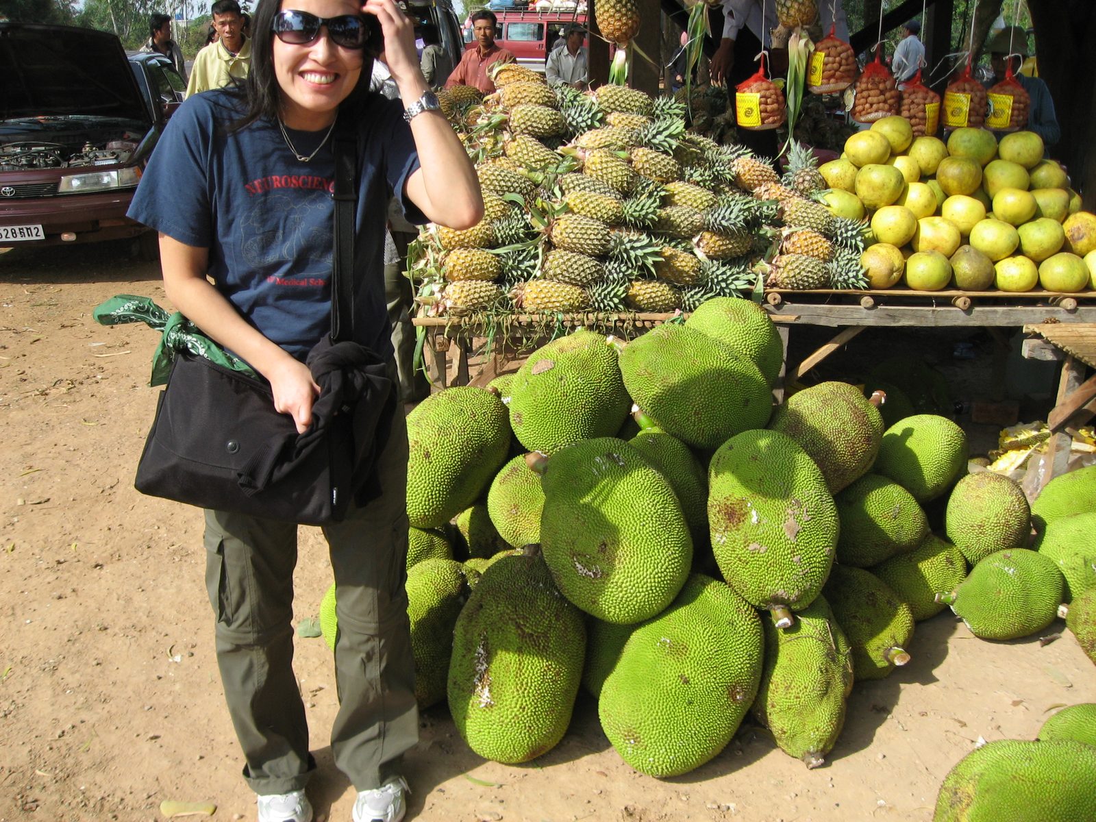 Helena poses in front of a pile of jack fruit at a market on the road between Phnom Penh and Siem Riep.