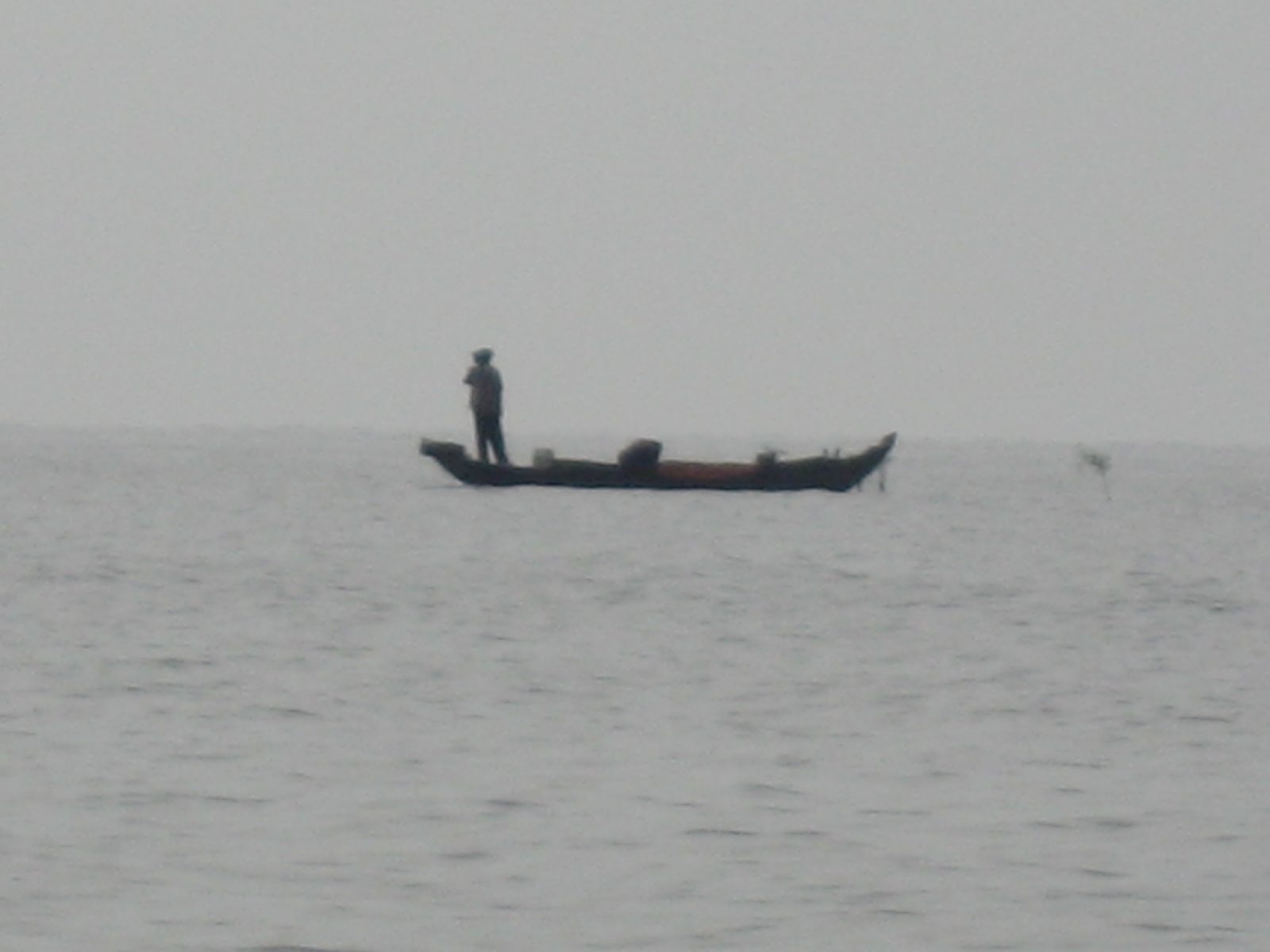 Lone fisherman in the Lake of the Tonle Sap.  This amazing lake quadruples in size during the...