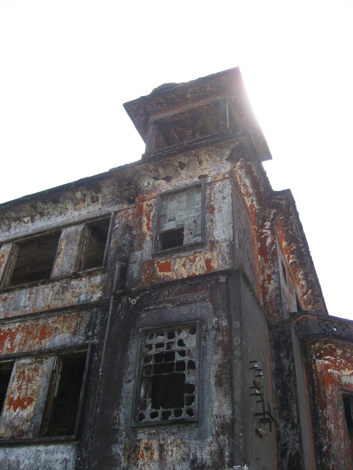 Bokor Hill Casino tower with sunlight behind it.