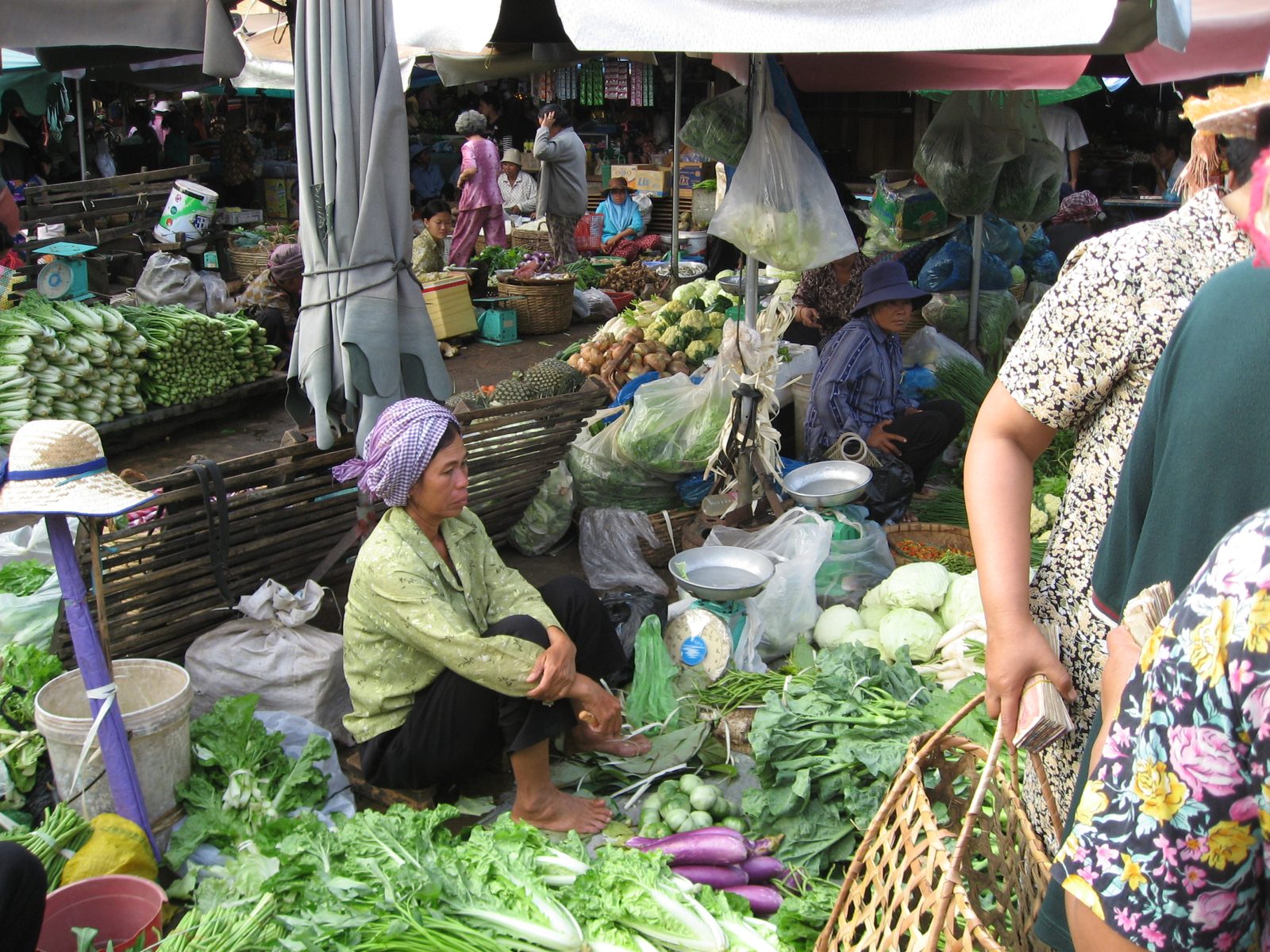 Woman selling vegetables at the Kampot market.