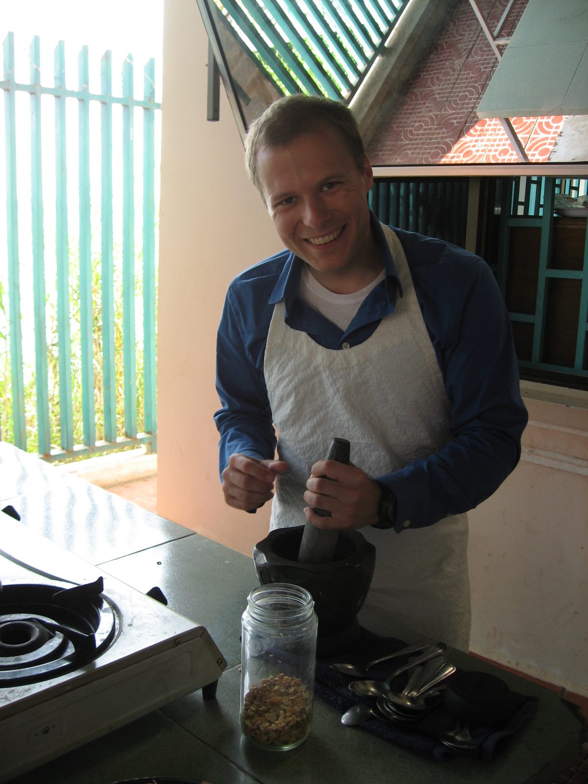 John, grinding peanuts into paste for spring rolls.