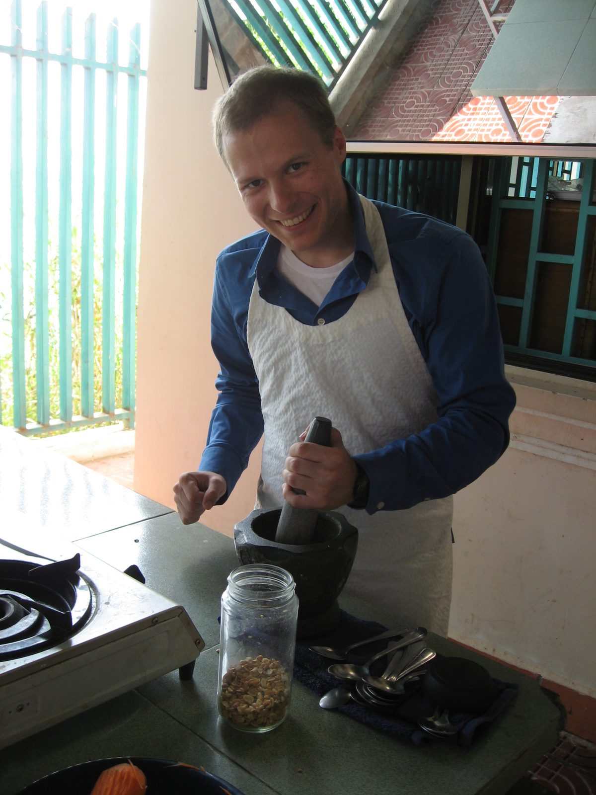 John mortar-and-pistil'ing some peanuts. 