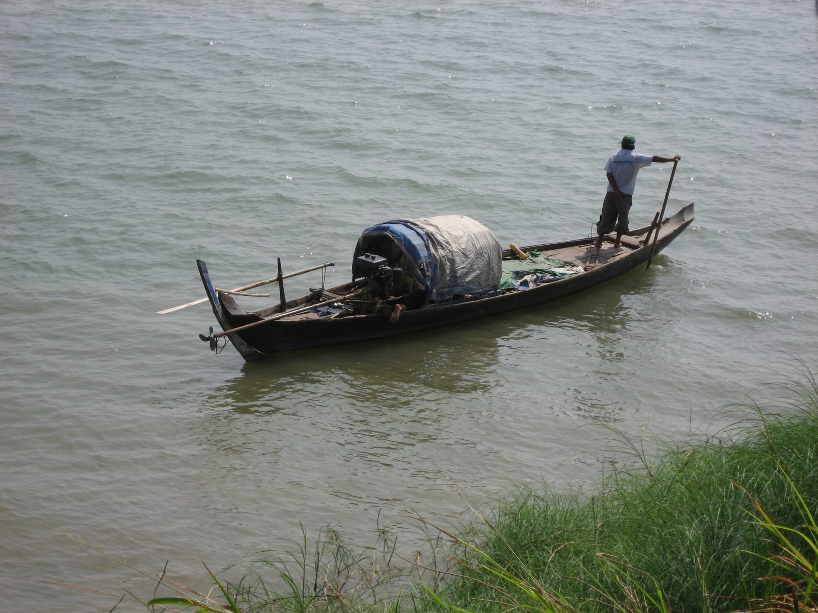 A fisherman rowing his way by our cooking class on the Mekong river.
