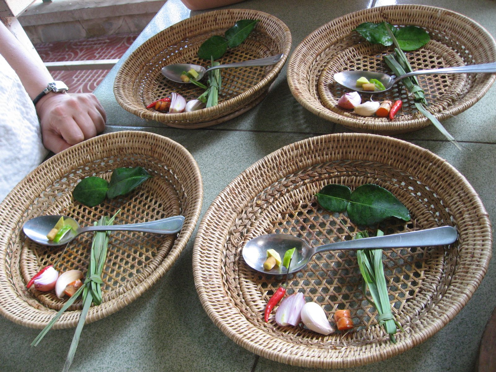 Ingredients for green curry.  All 4 students' plates ready for mortar and pistil.