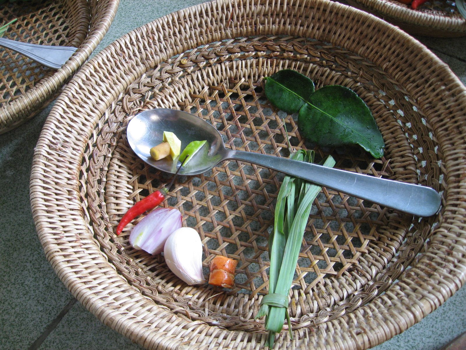 Close-up of ingredients for green curry.  Kafir lime leaves, lemon grass (not the root part...
