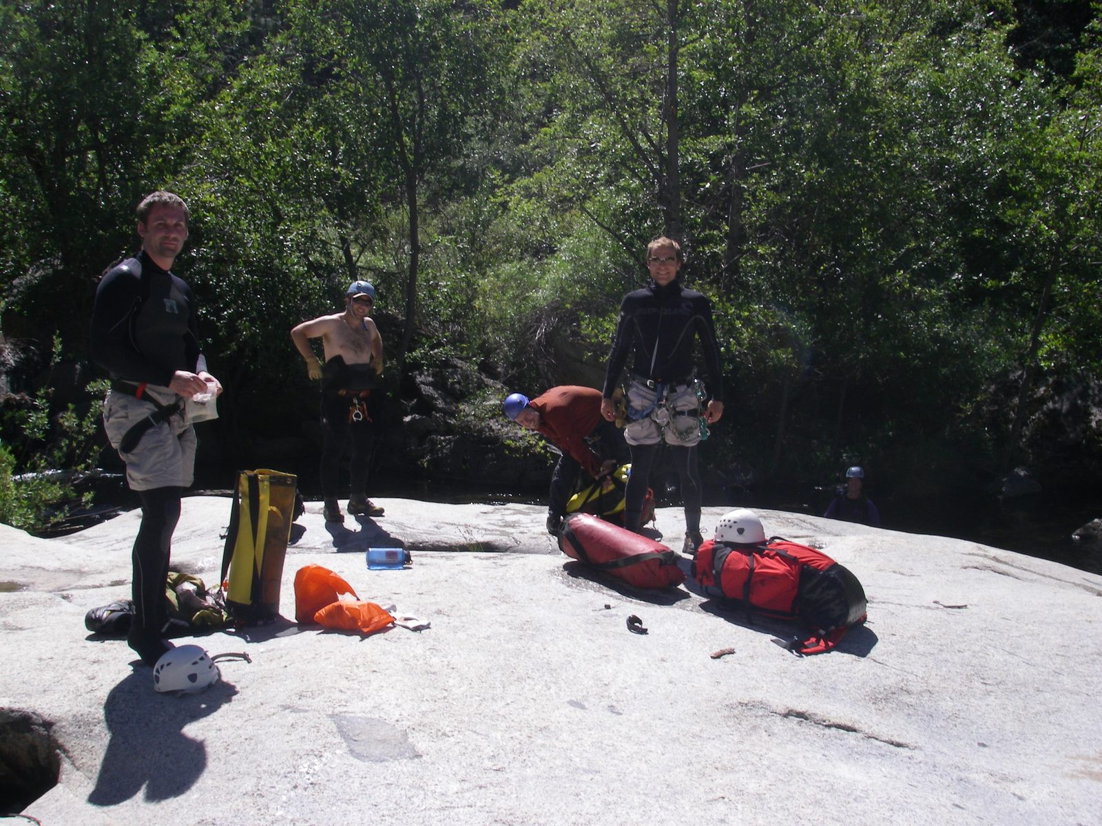 Putting on wet suits and getting ready to jump in the river