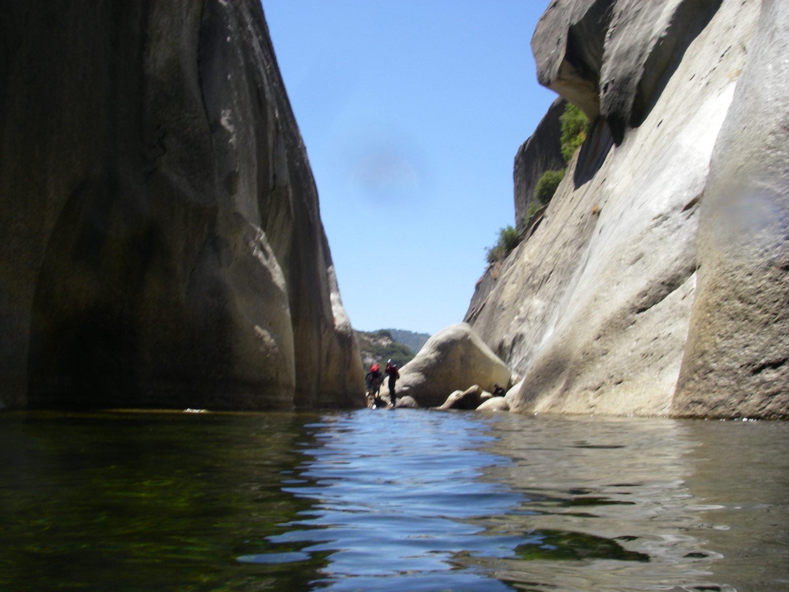John and Joel, near the top of a jam in the river, looking for the next rappel bolts.