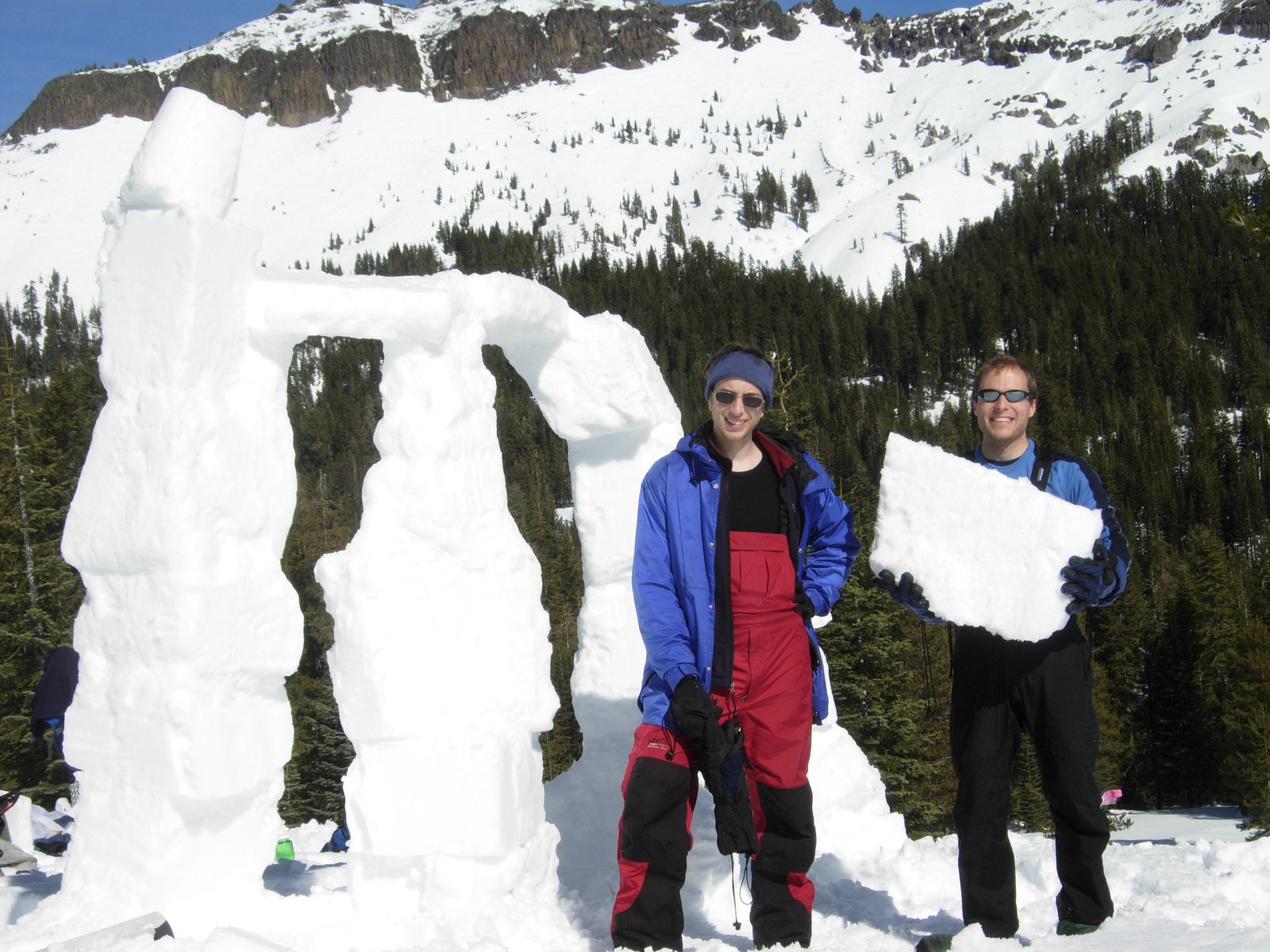 John holding an extra snow-brick in front of Snowhenge.  David at left.