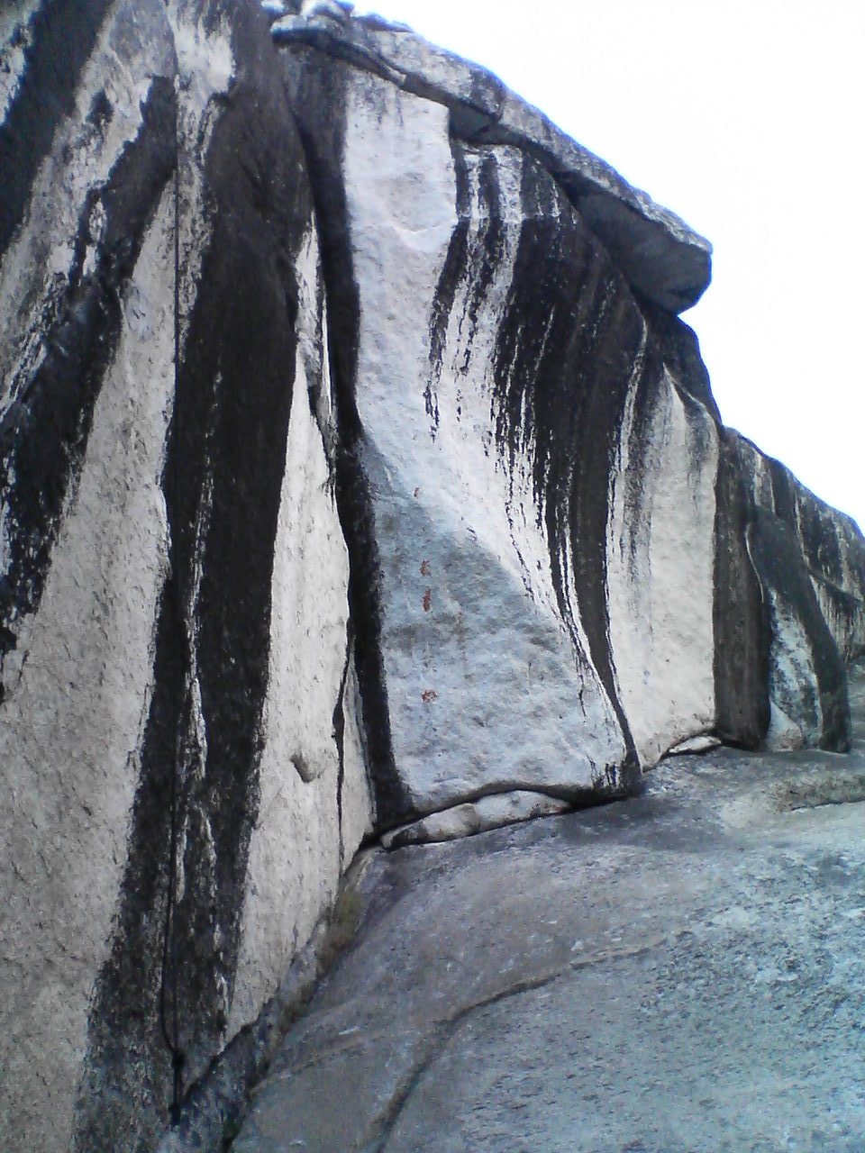 Completely evil overhung slanted finger crack in Olmsted Canyon.  Note the permanent top rope...