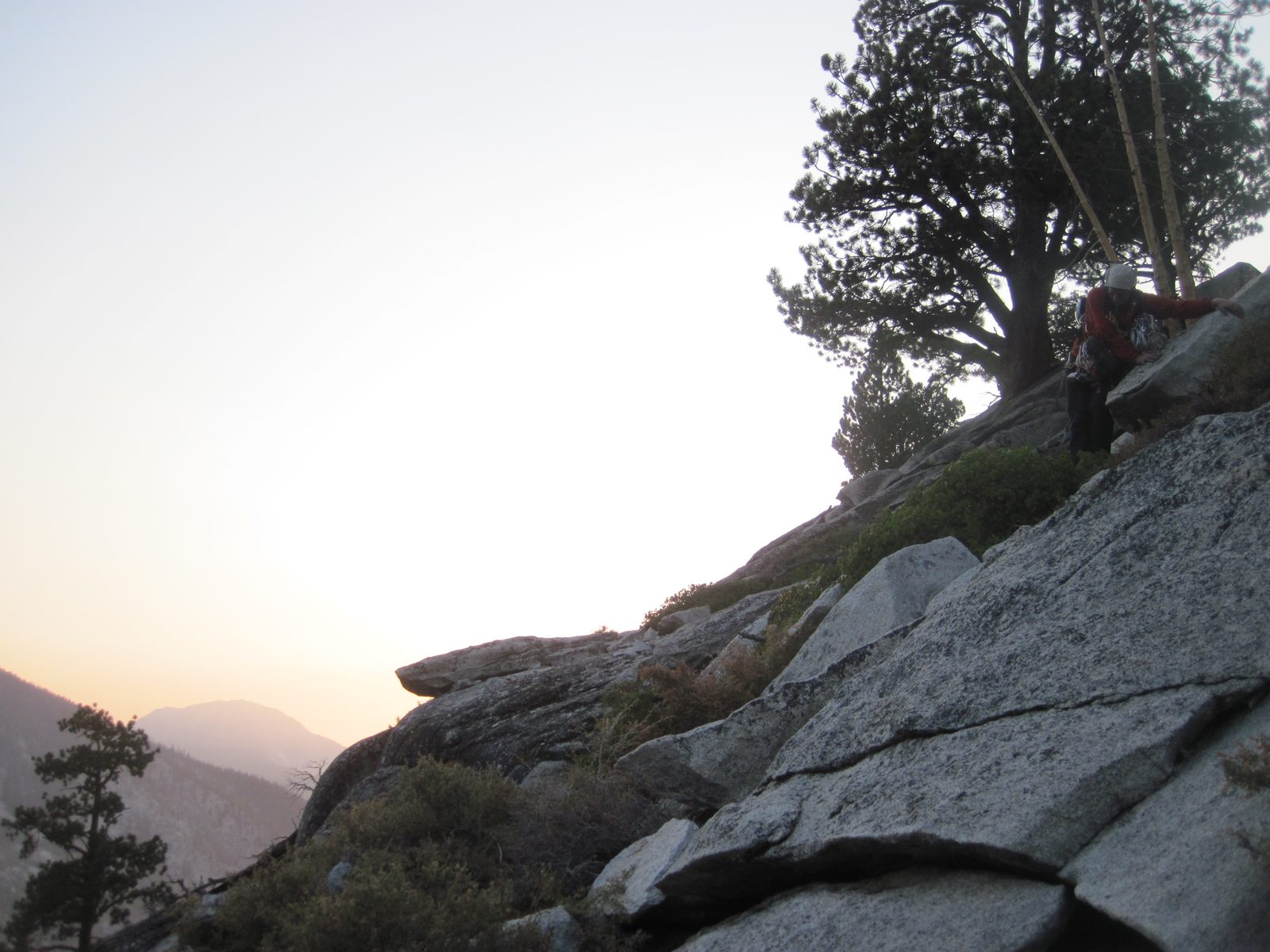 Joel works carefully across an exposed granite ledge.