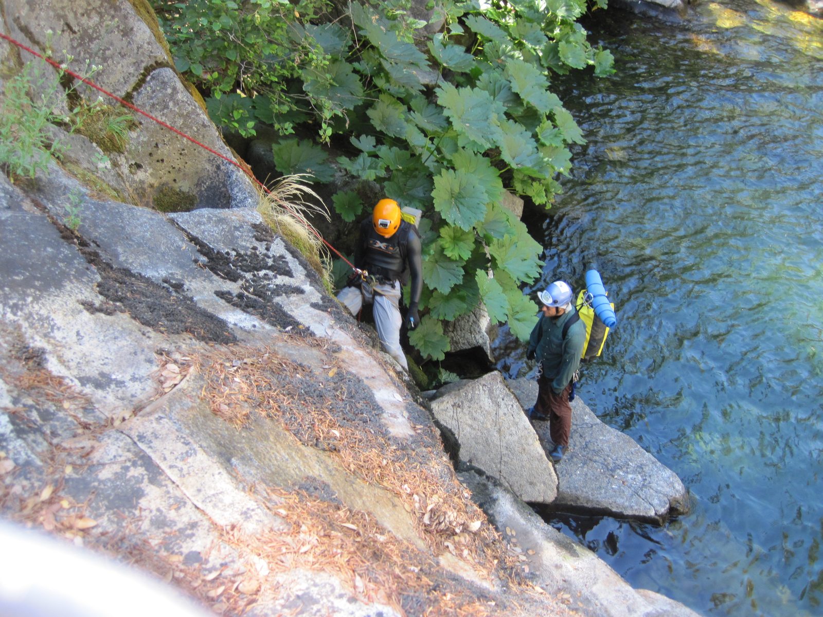 Joel spotting Yang as he rappels down the first obstacle after lunch.