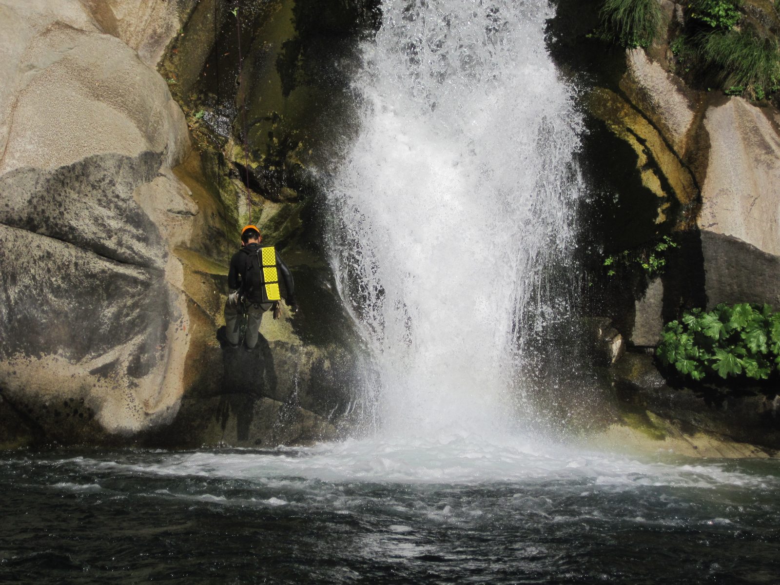 Yang, rappelling next to the falls.