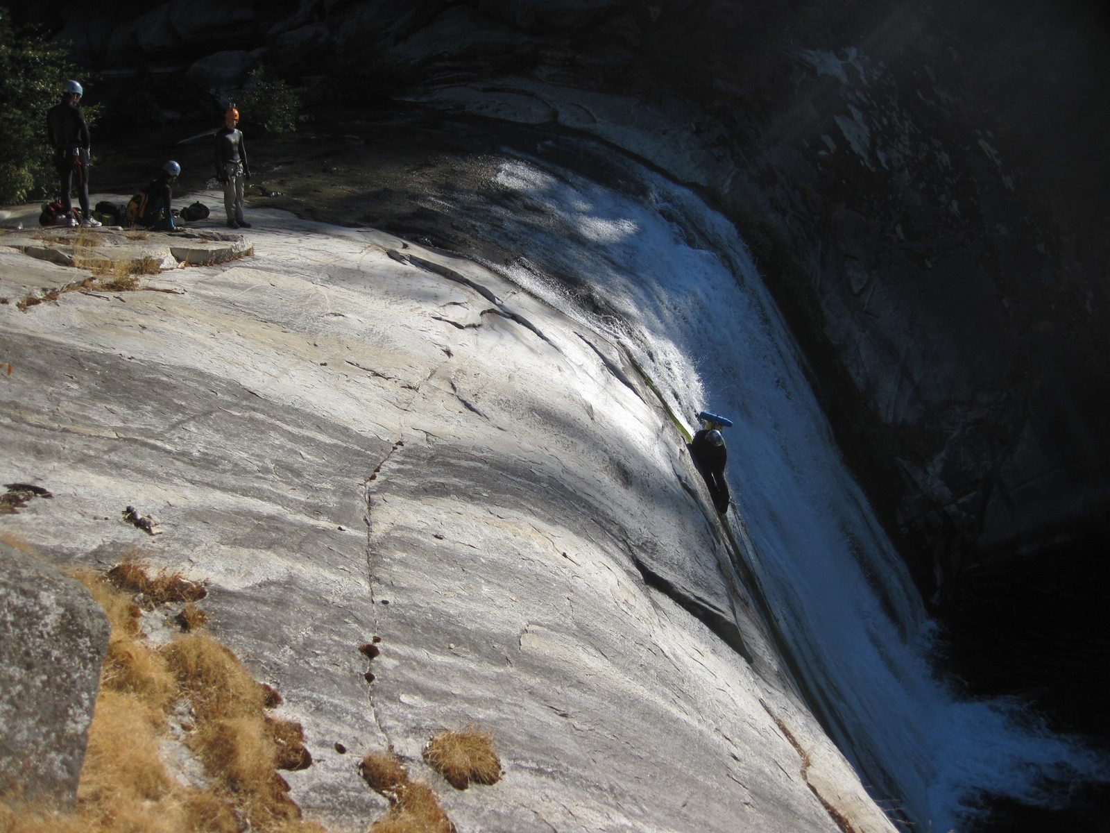Joel on rappel, sliding on his hip to prevent slipping.