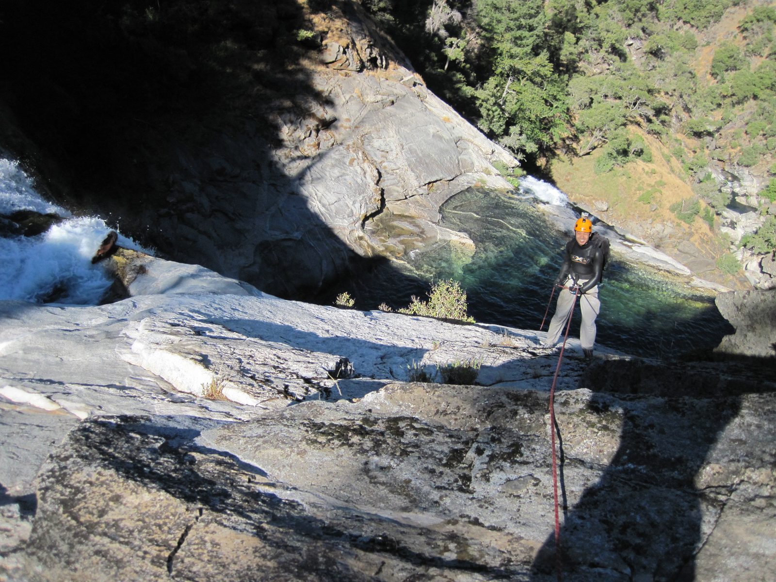 Yang, rappelling into the shade.
