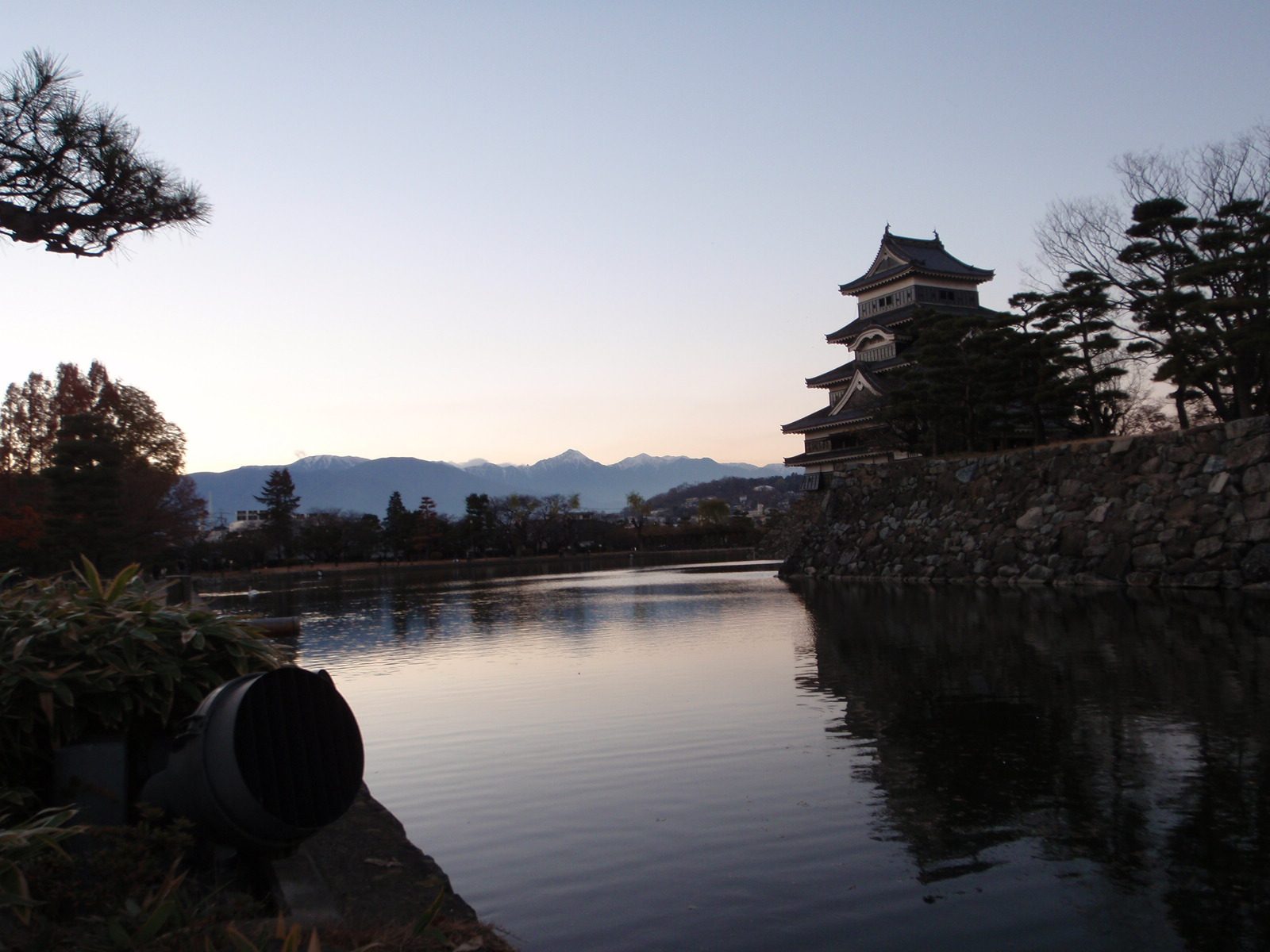 Castle with snow capped peaks in the distance.