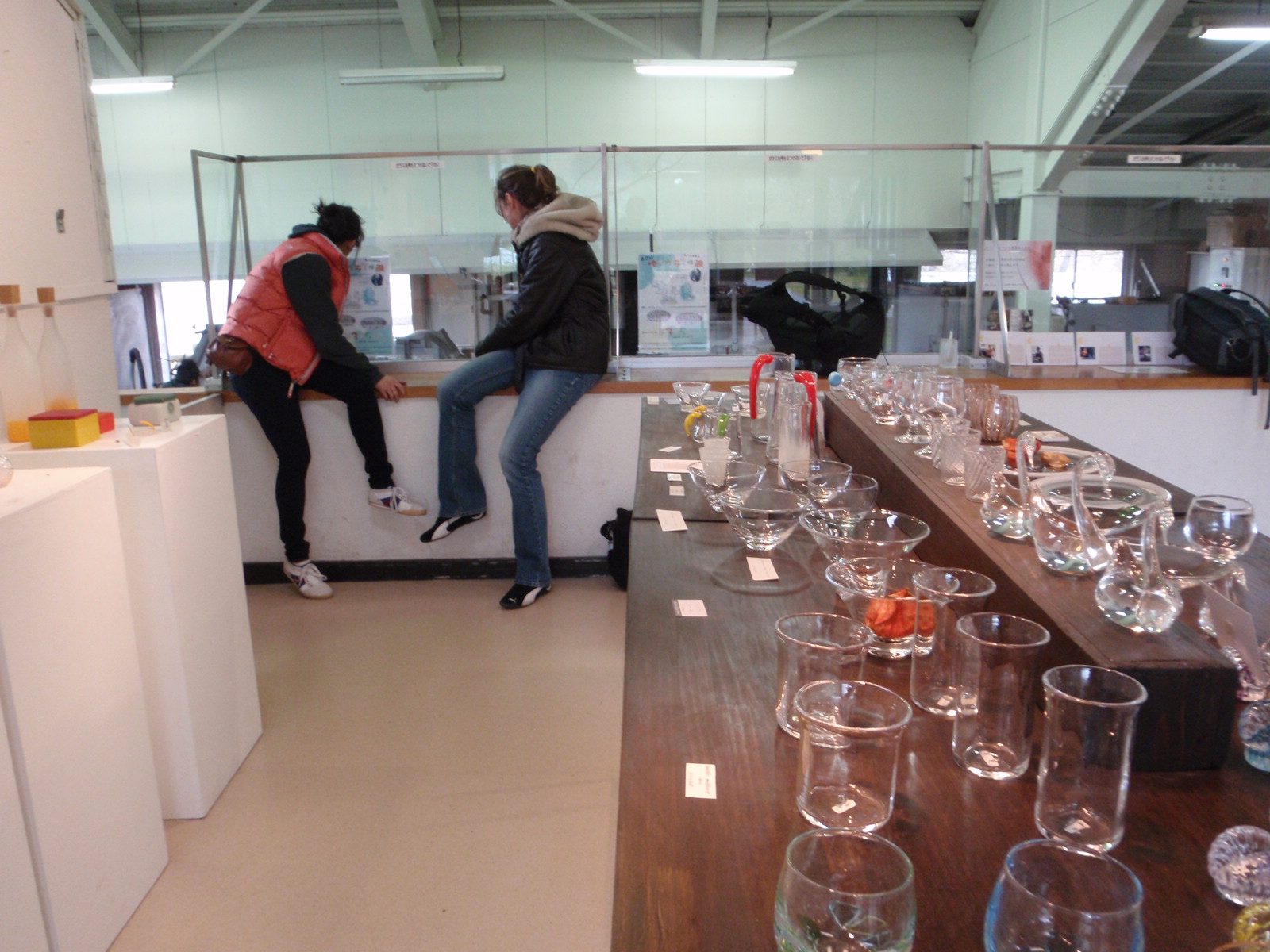 Sara and Jennie watch the glass blowers.
