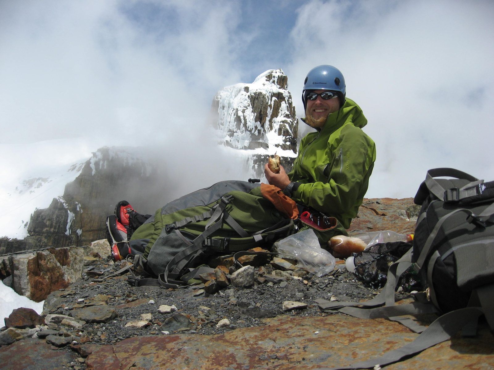 John eating lunch on the summit, with a false summit of Concavo in the background.  We would...