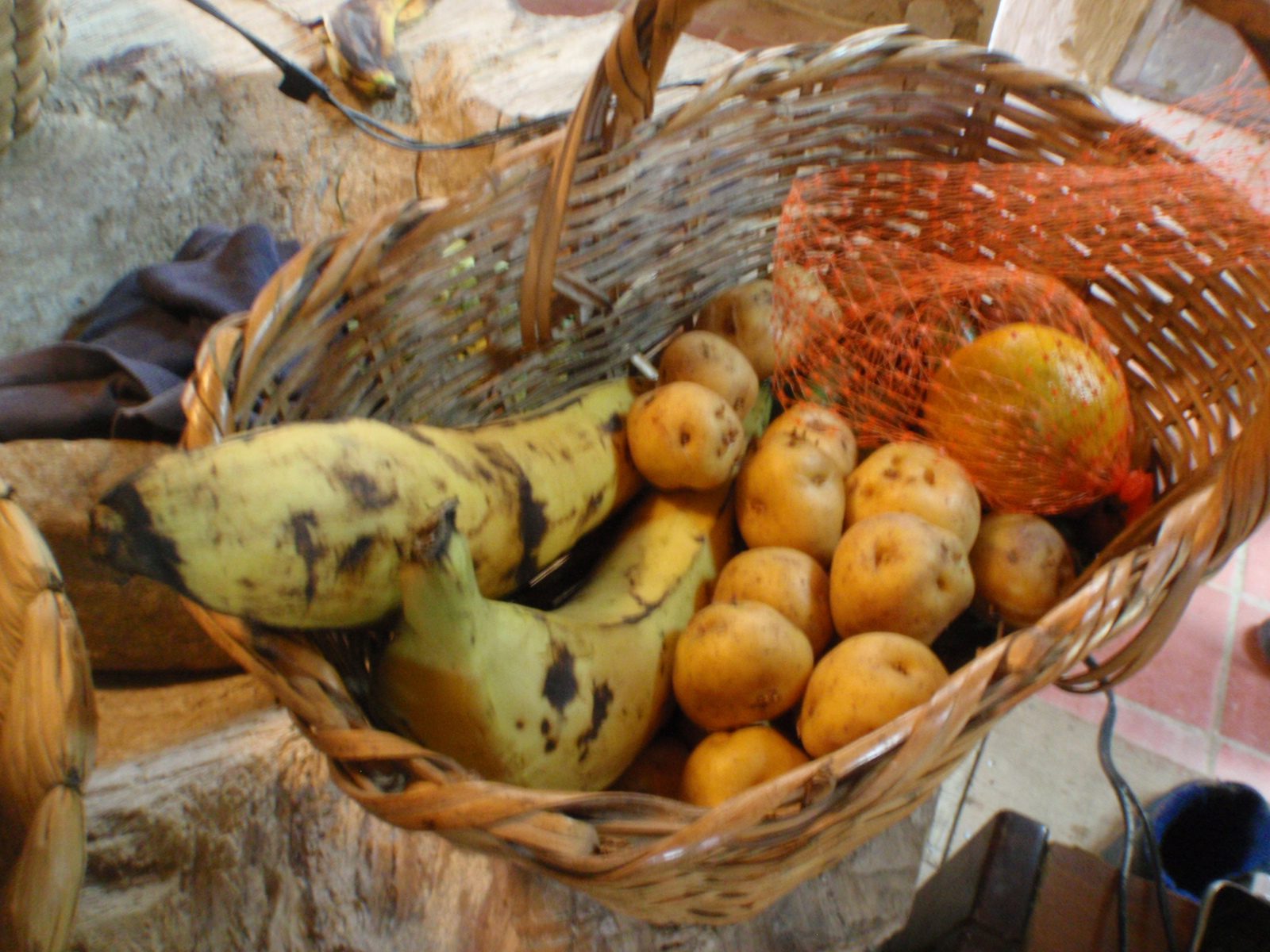 Local potatoes and plantains in my guide's kitchen.  Most houses here do not have a...