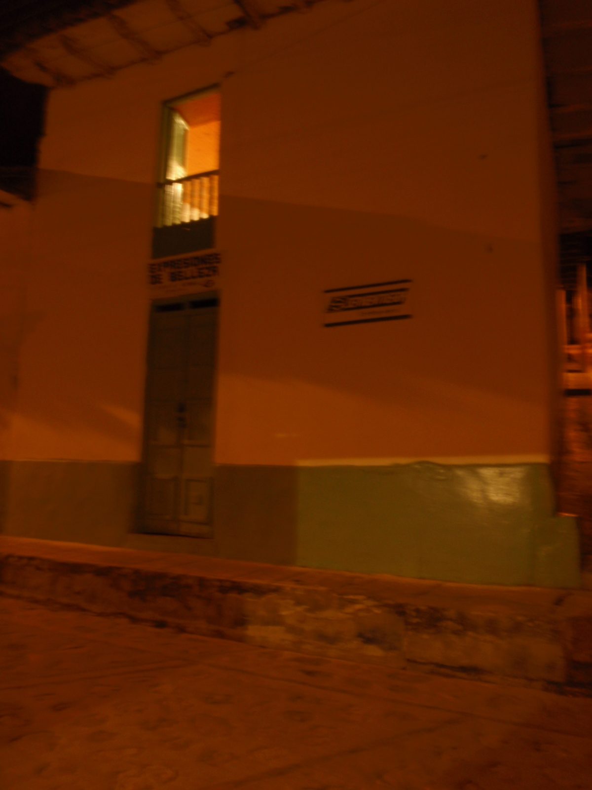 My bedroom window (lit) from the street outside.