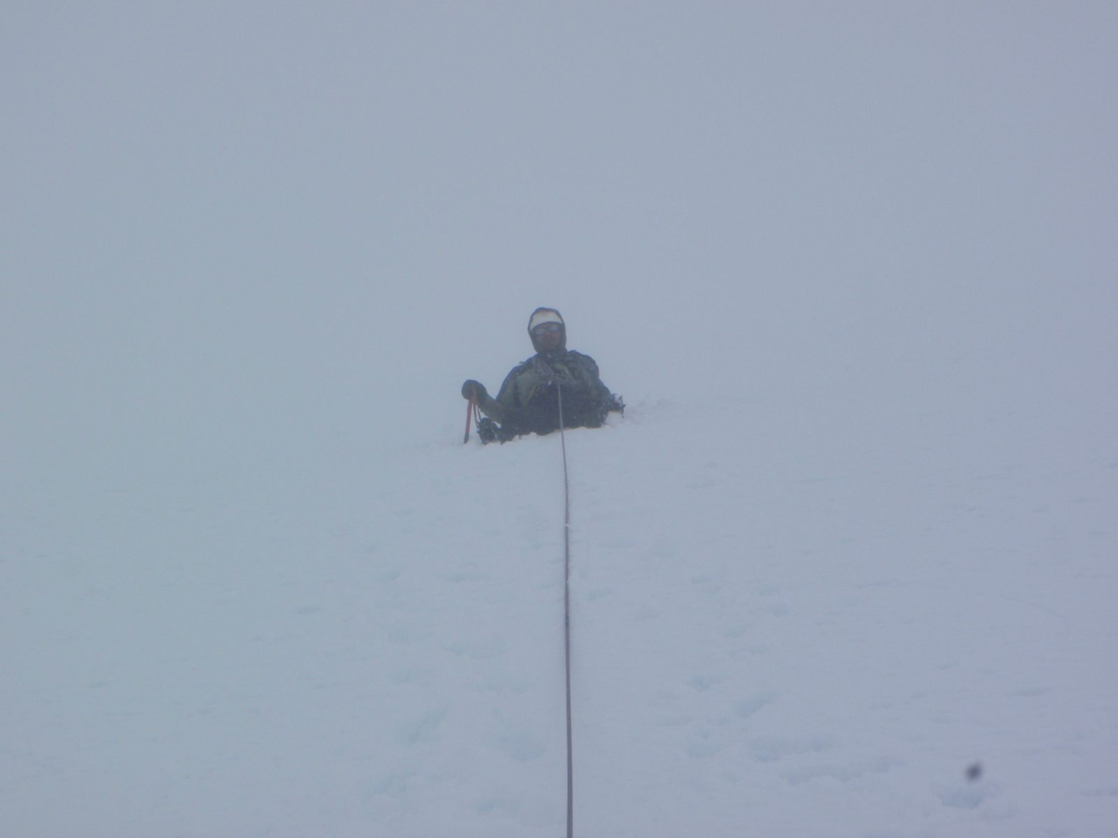 My guide keeping the rope tight as I cross a crevasse on the way down.