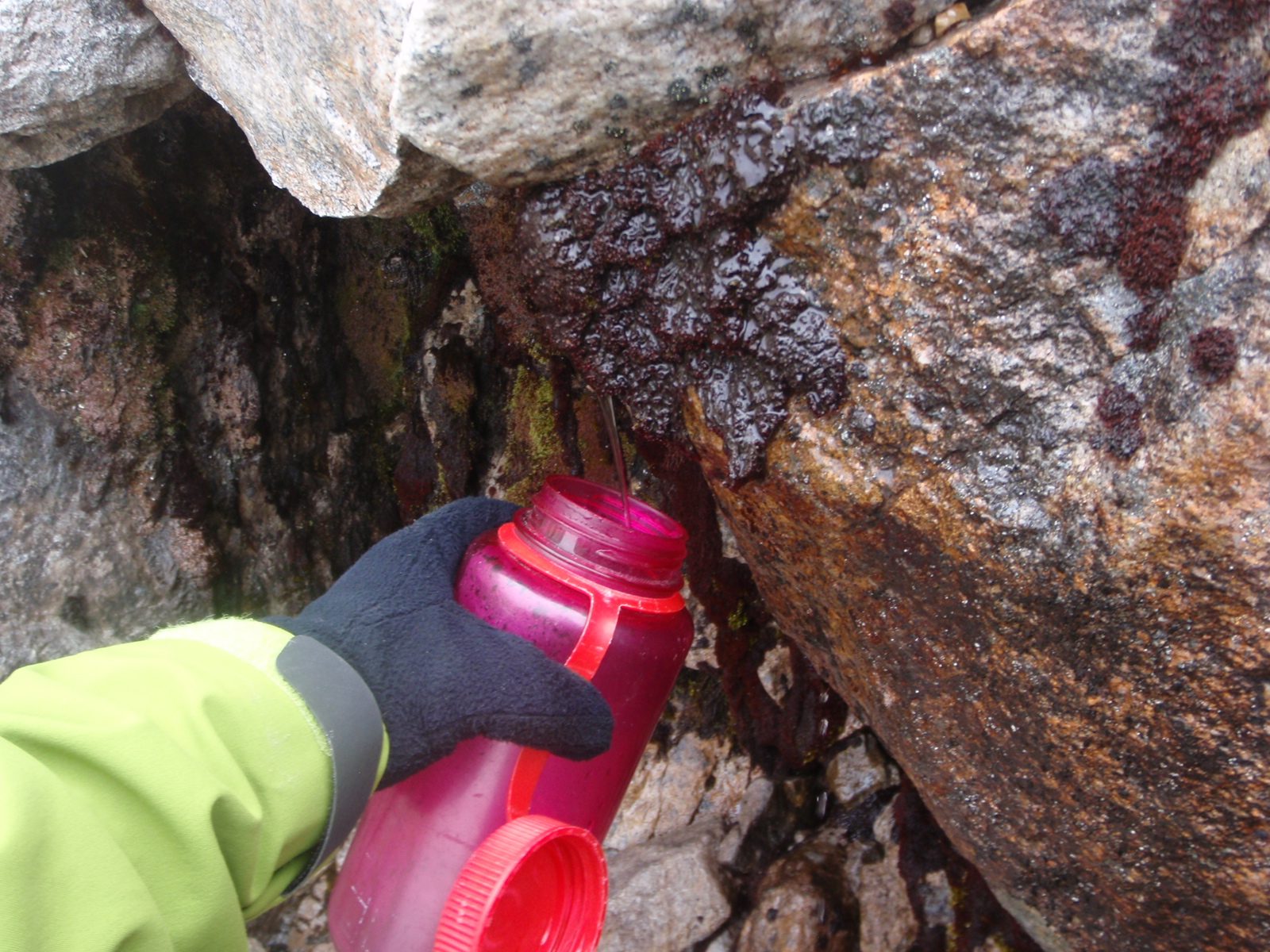 Getting some water from a small glacial melt spring.