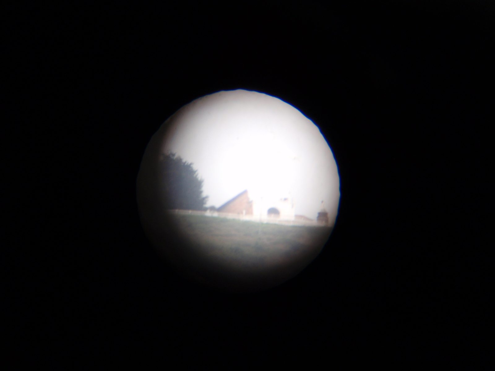 Taking a photo of Monserrate through the telescope.
